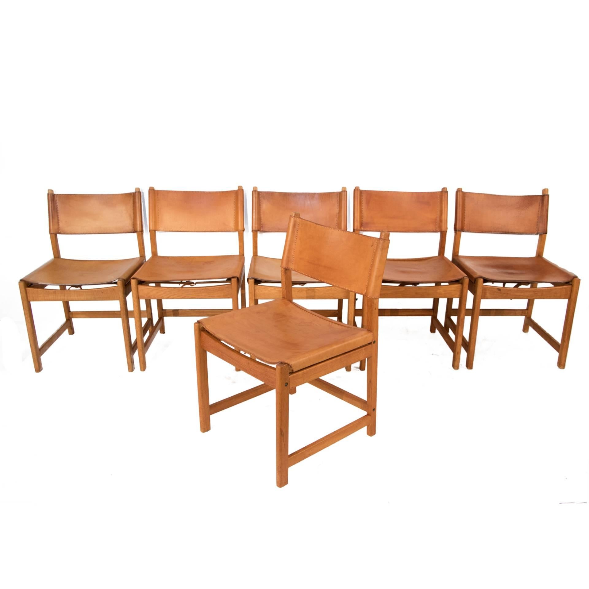 Set of six oak and leather dining chairs by Kurt Ostervig.