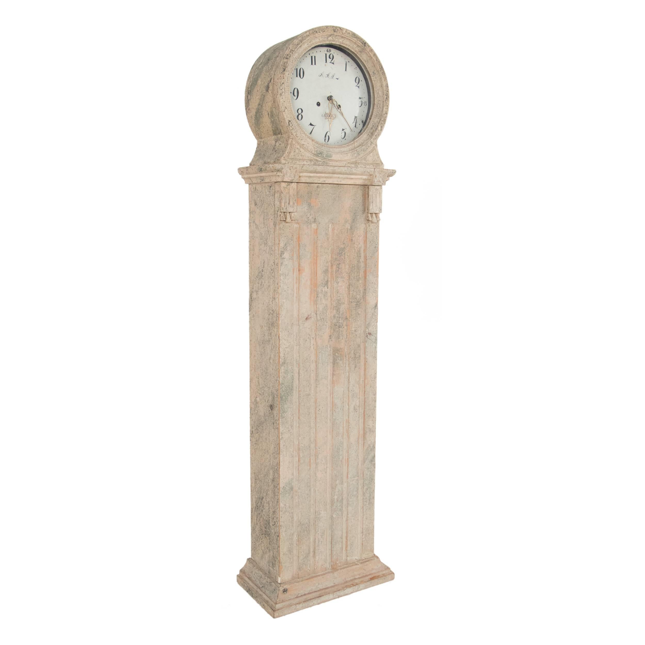 Gustavian grandfather clock in a worn pale marbleized patina.