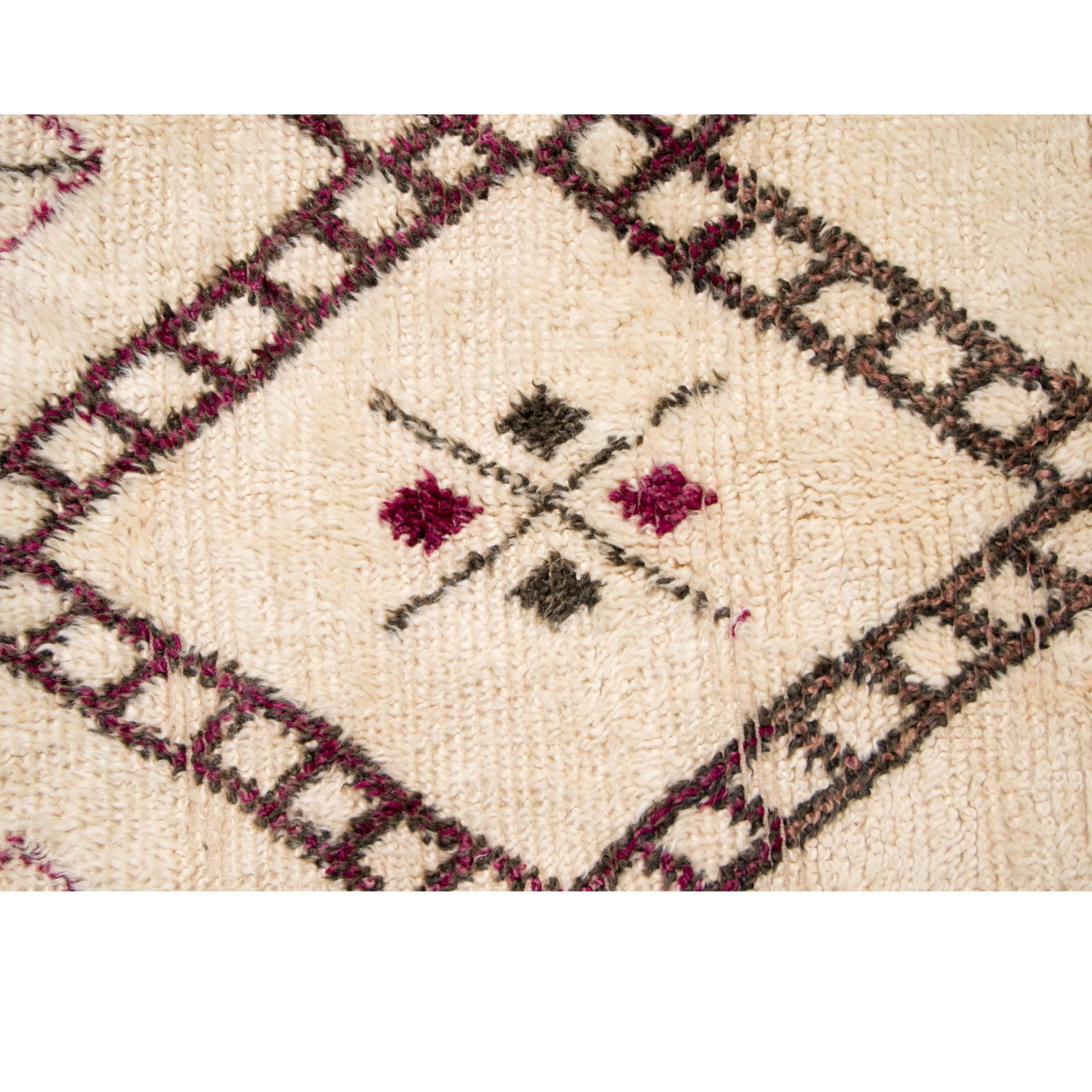 Vintage handwoven wool rug by the Beni Ourain Tribe.