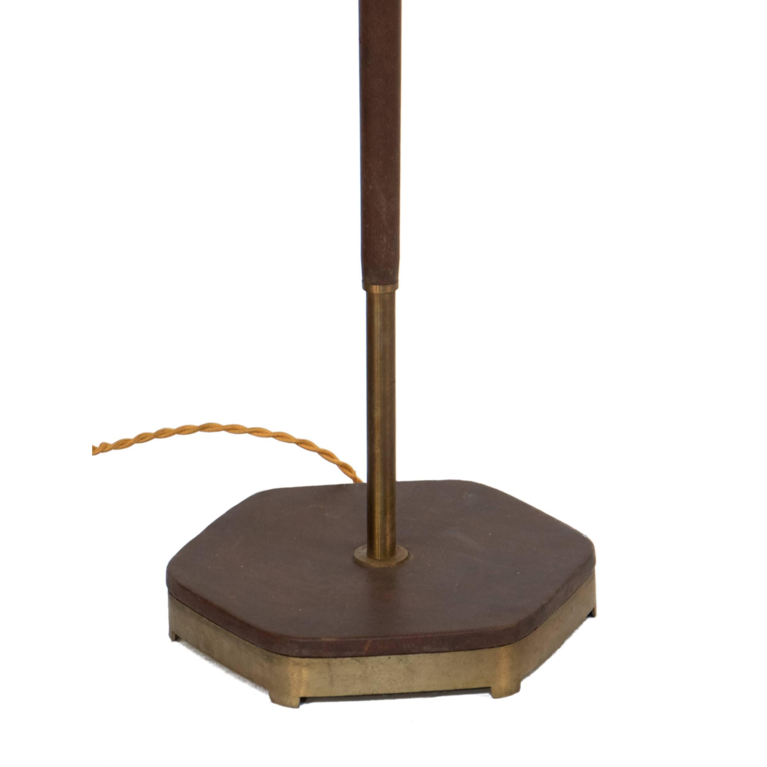 Brass and leather floor lamp.