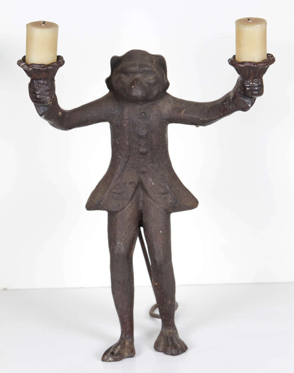 Redcoat monkey candleholder (possible British or Colonial American) is solid iron and beautifully scaled to be candleholder on a tabletop, console or mantel.