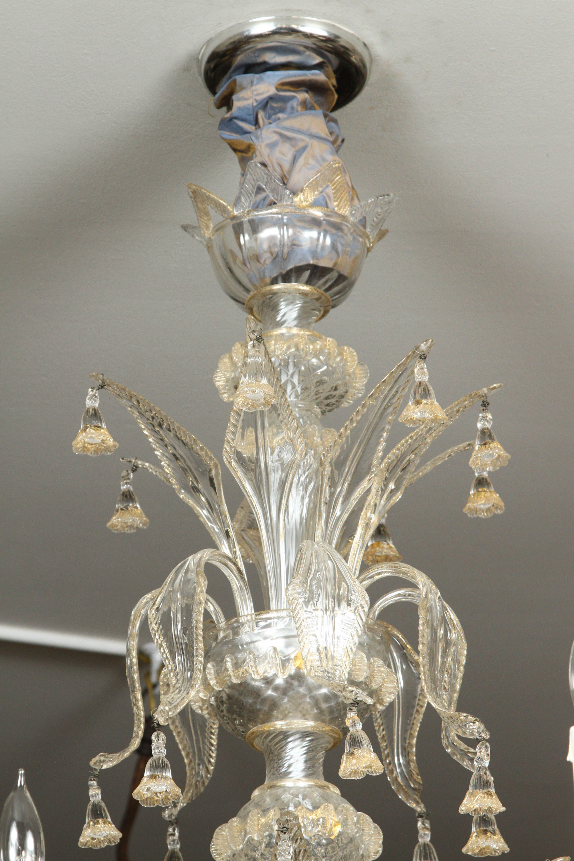 Gorgeous handblown eight-light Venetian glass chandelier with gold fleck accents and a flower motif. PLEASE NOTE: Parcel Delivery is not an option for this item. White Glove or Front Door Freight required.