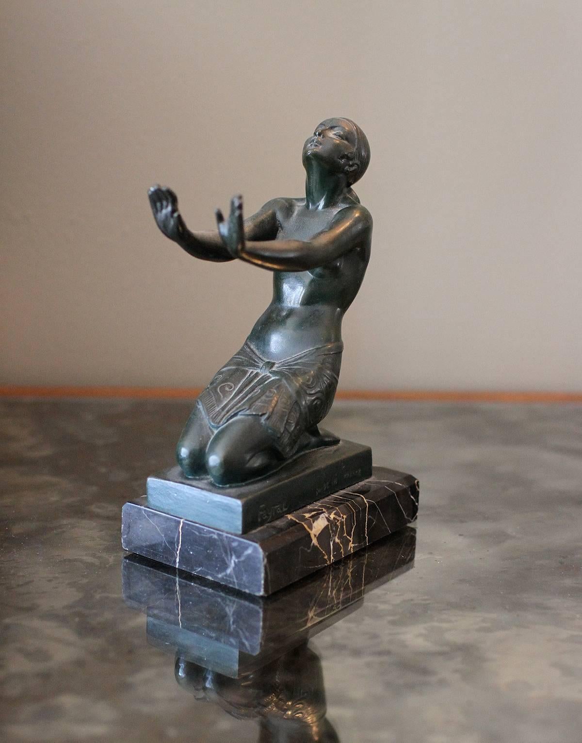 Pierre Le Faguays (1892-1962), dit Fayral. 
Beautiful bronze sculpture, signed Fayral, pseudonym of Pierre Le Faguays, depicting kneeling nude lady with stretched out arms, on a black Portor marble base.
We have two of these that can be used as