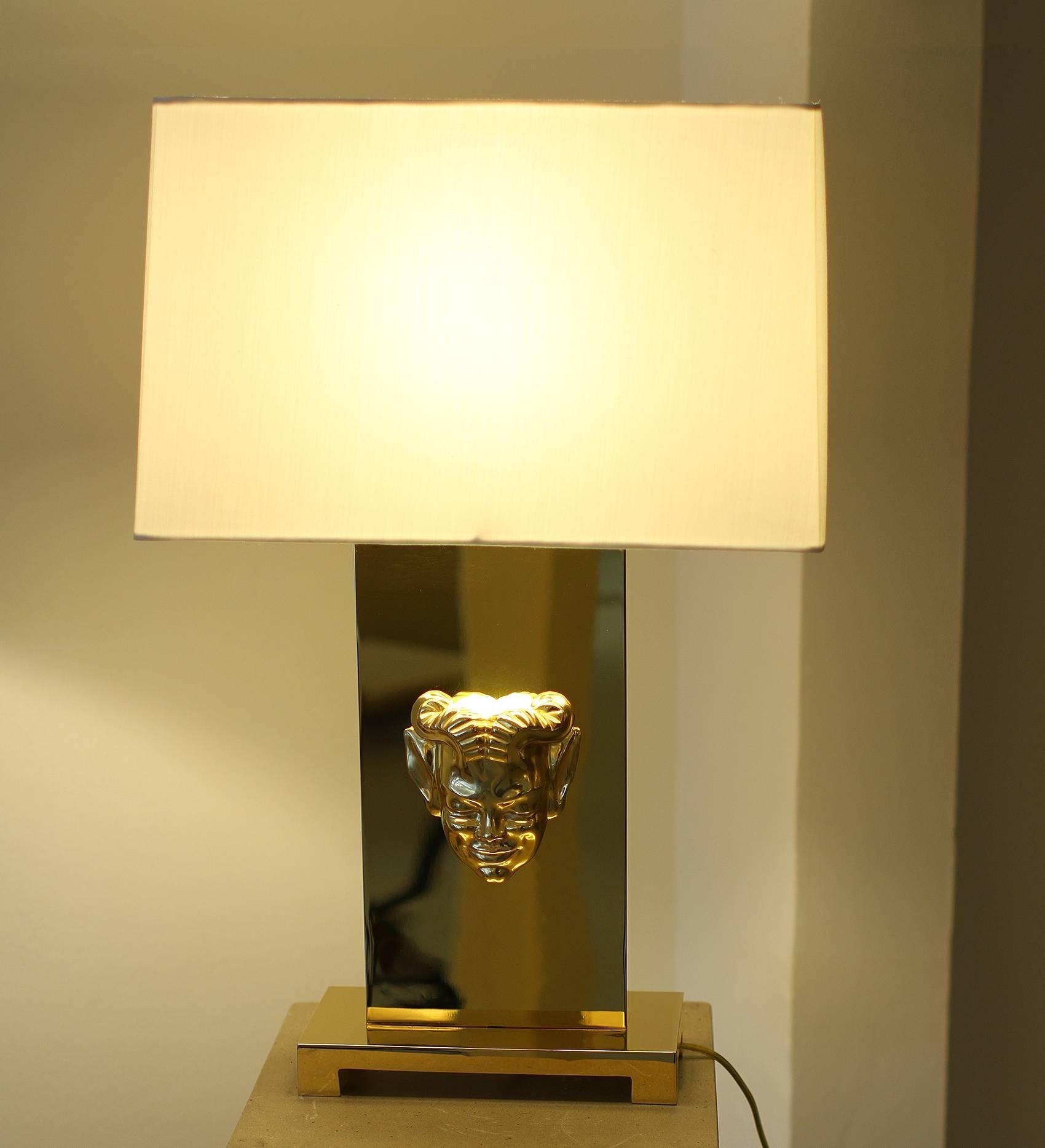 Pair of gilt bronze table lamps by Philip Neri, France/USA
Amazing work of gold plating. Each lamp is wired for US with a 40w or 60w light bulb diffusing the light into an ivory pongee custom lampshade. The mask also includes a low voltage light.
