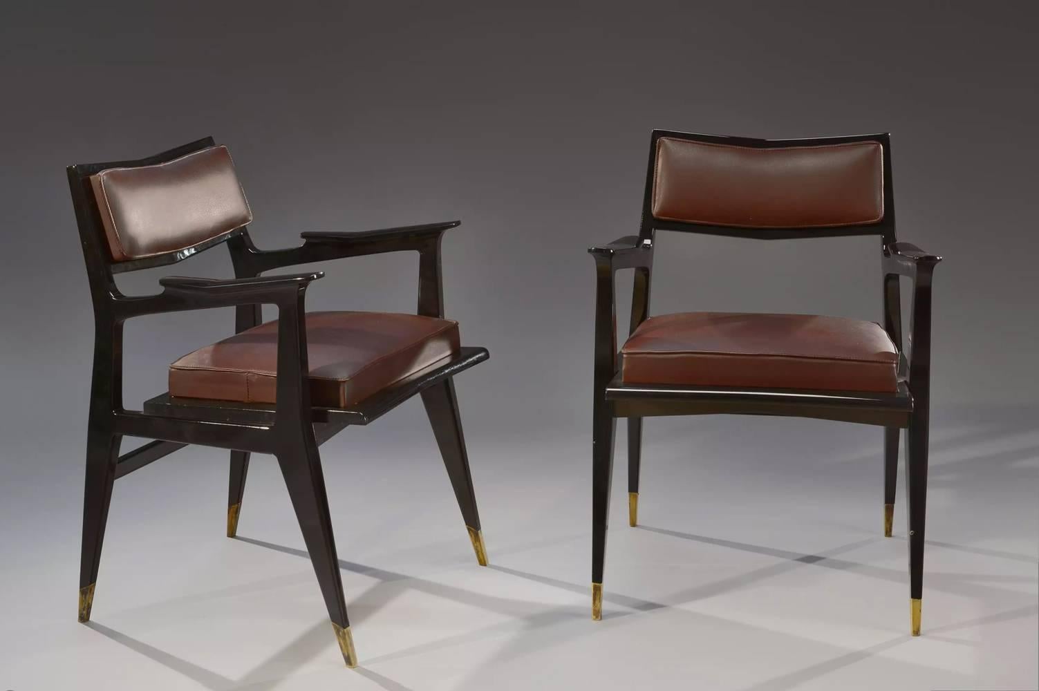 Raphaël (1912-2000).

Beautiful and rare pair of chairs in black lacquer terminated with gilt bronze sockets.
Seats and backs upholstered in double stitch burgundy leather.
Signed 