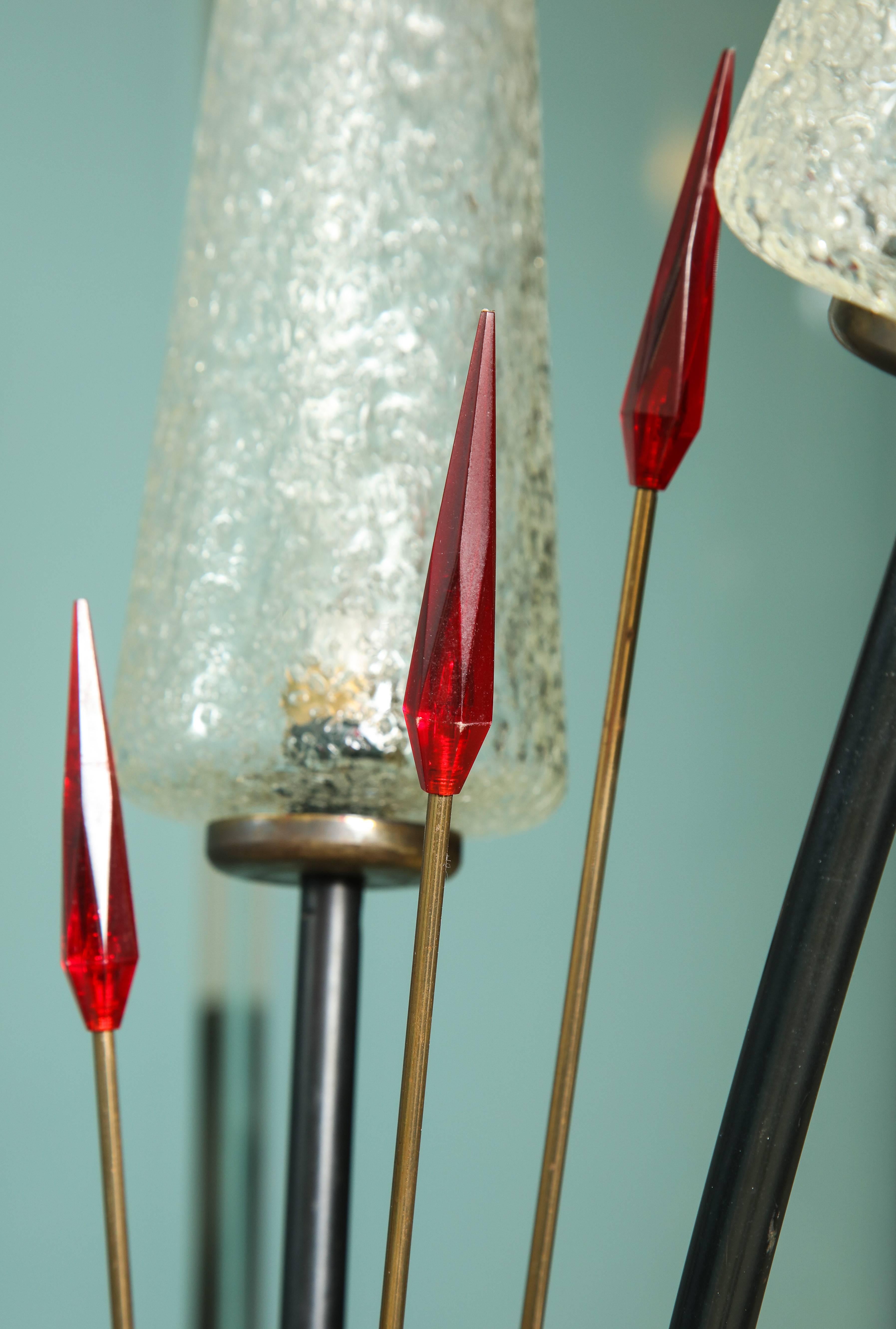 This is a great Stilnovo style floor lamp with three crackle glass shades and
red Lucite accents. Makes a statement.