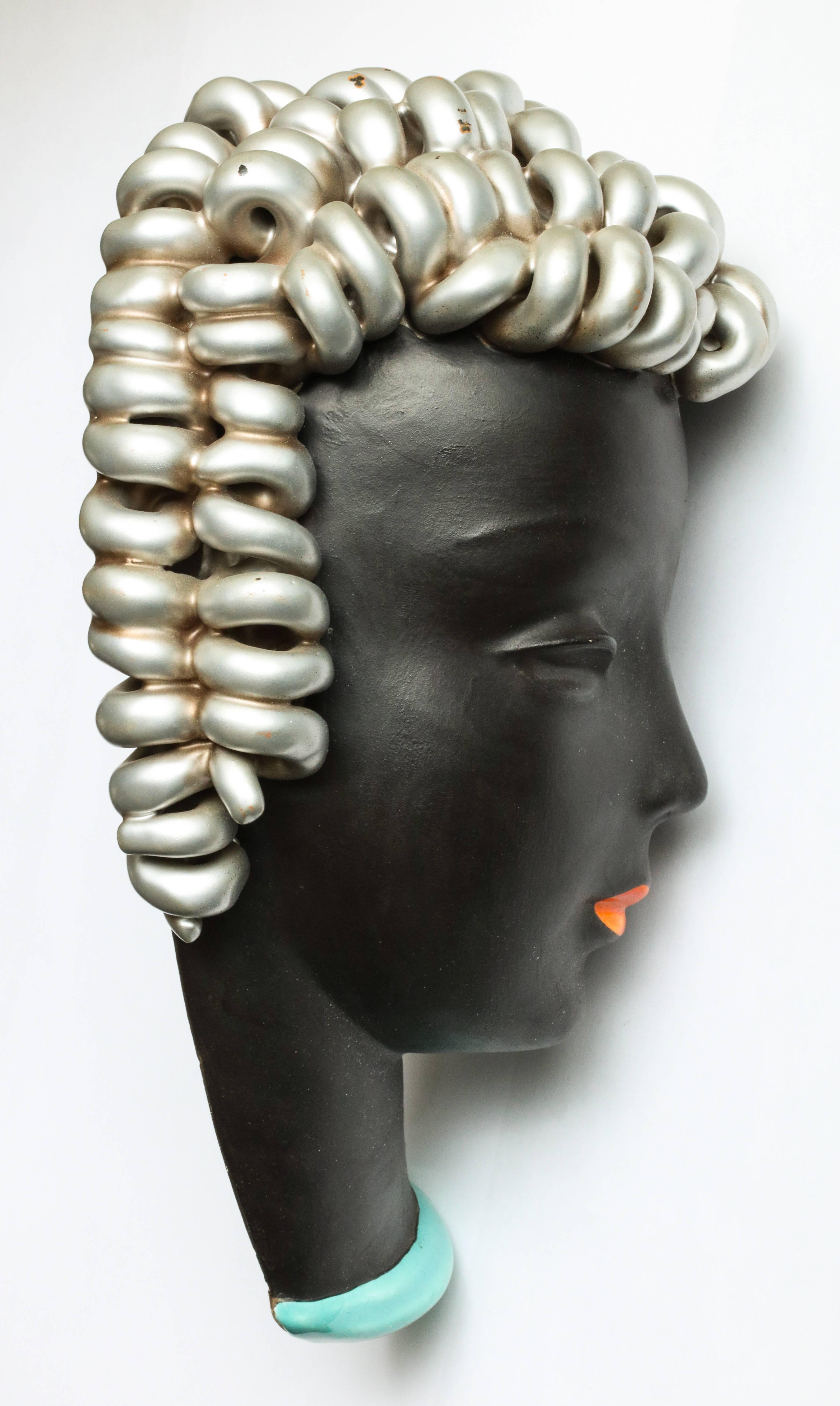 A stylish ceramic wall bust with silvered hair by the Austrian maker Goldschieder. Marked on the back.