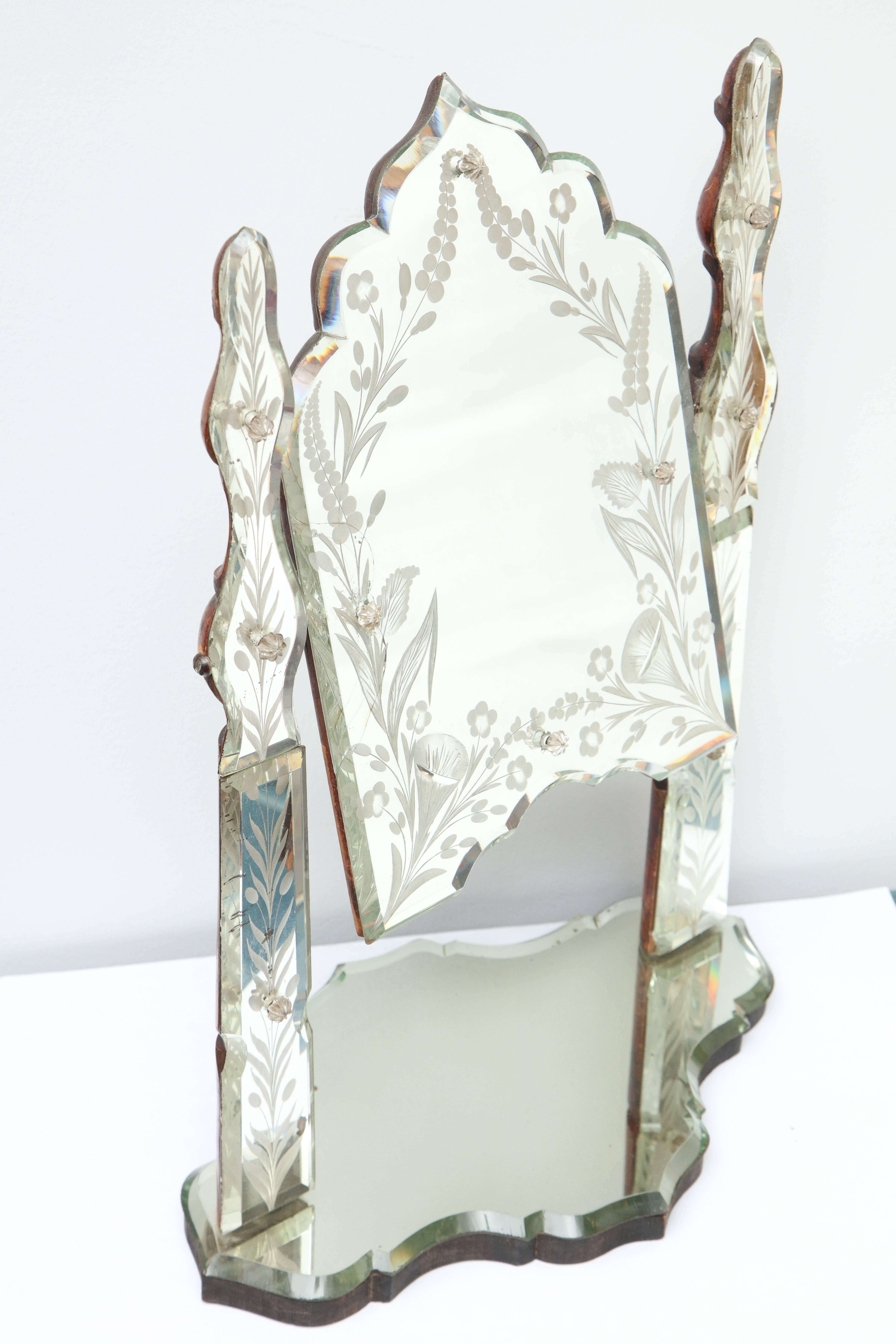 A wonderfully etched and bevelled mirror on a moveable/tilt stand.
This is a very unusual piece to find and enhances  any vanity or table.