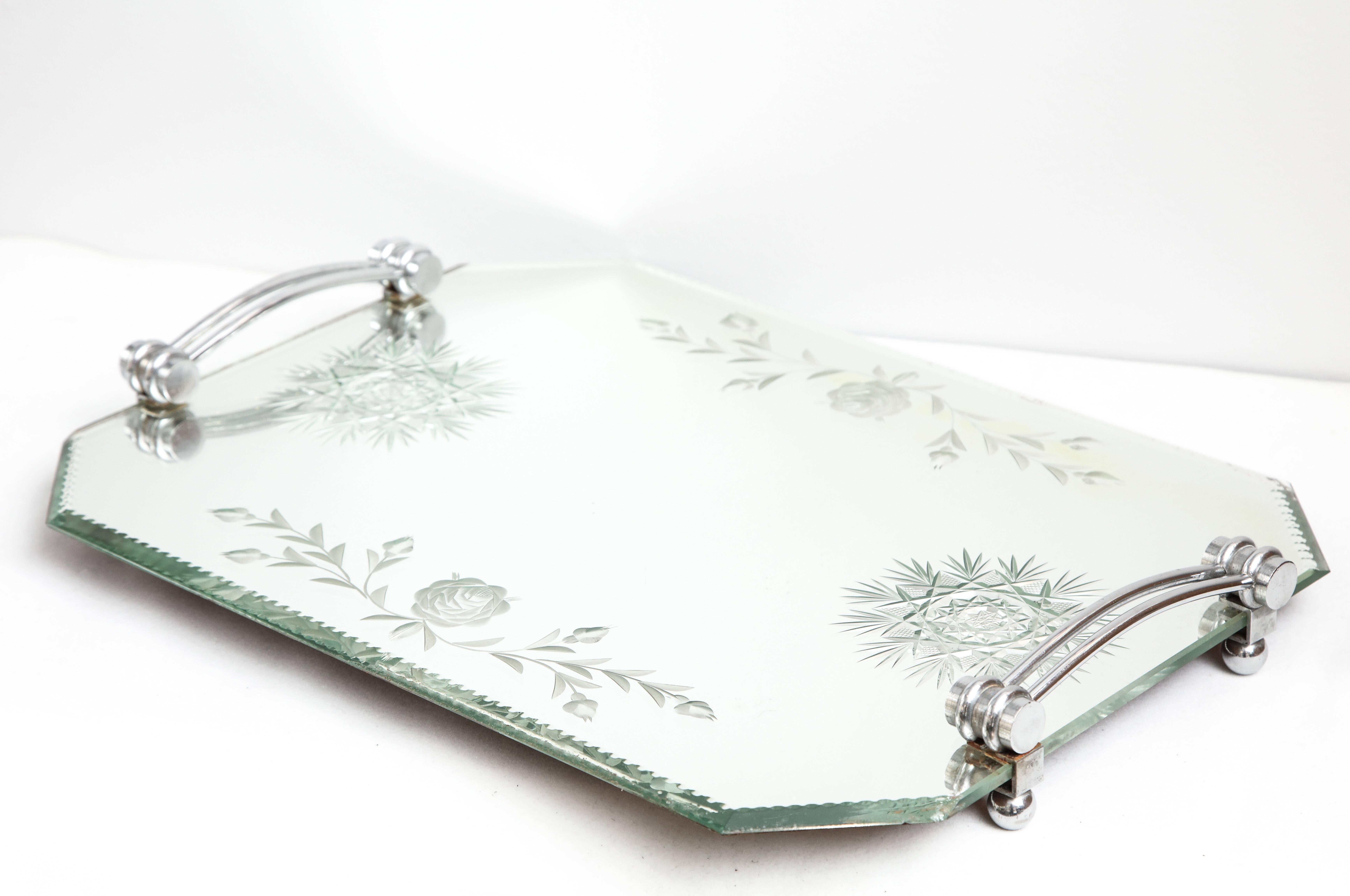 A fabulous French deeply etched and bevelled mirrored vanity tray with deco chrome handles and mounted on chrome feet.