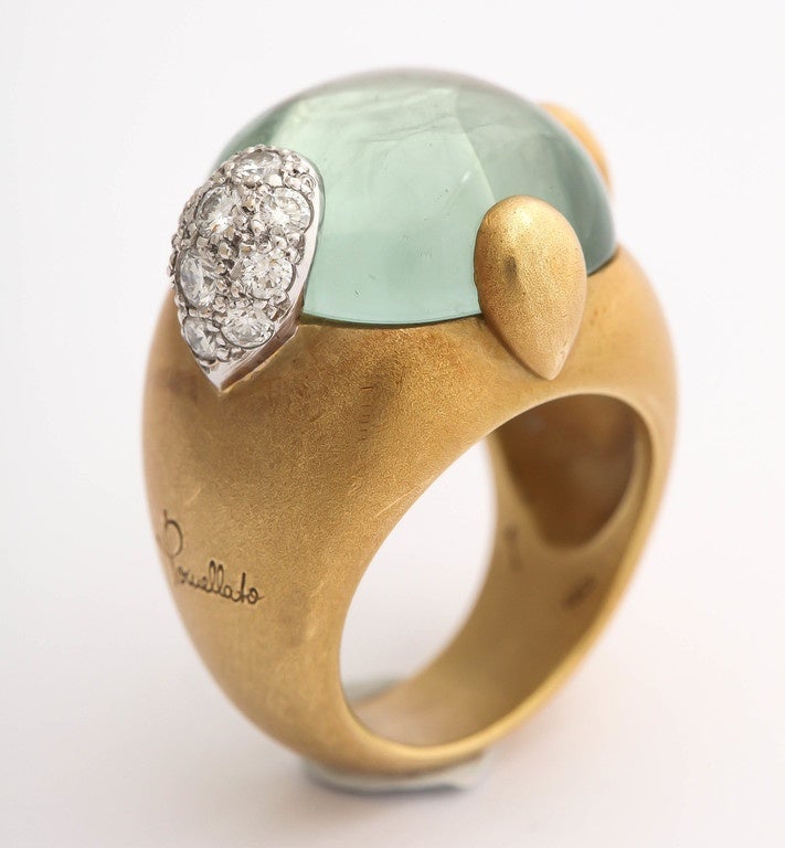 A fabulous significant satin 18 karat gold ring with a large green aquamarine cabochon and diamond pear-shape cluster set in platinum. This is a lovely art piece from the earlier collection that can be worn always. Signed by Pomellato.