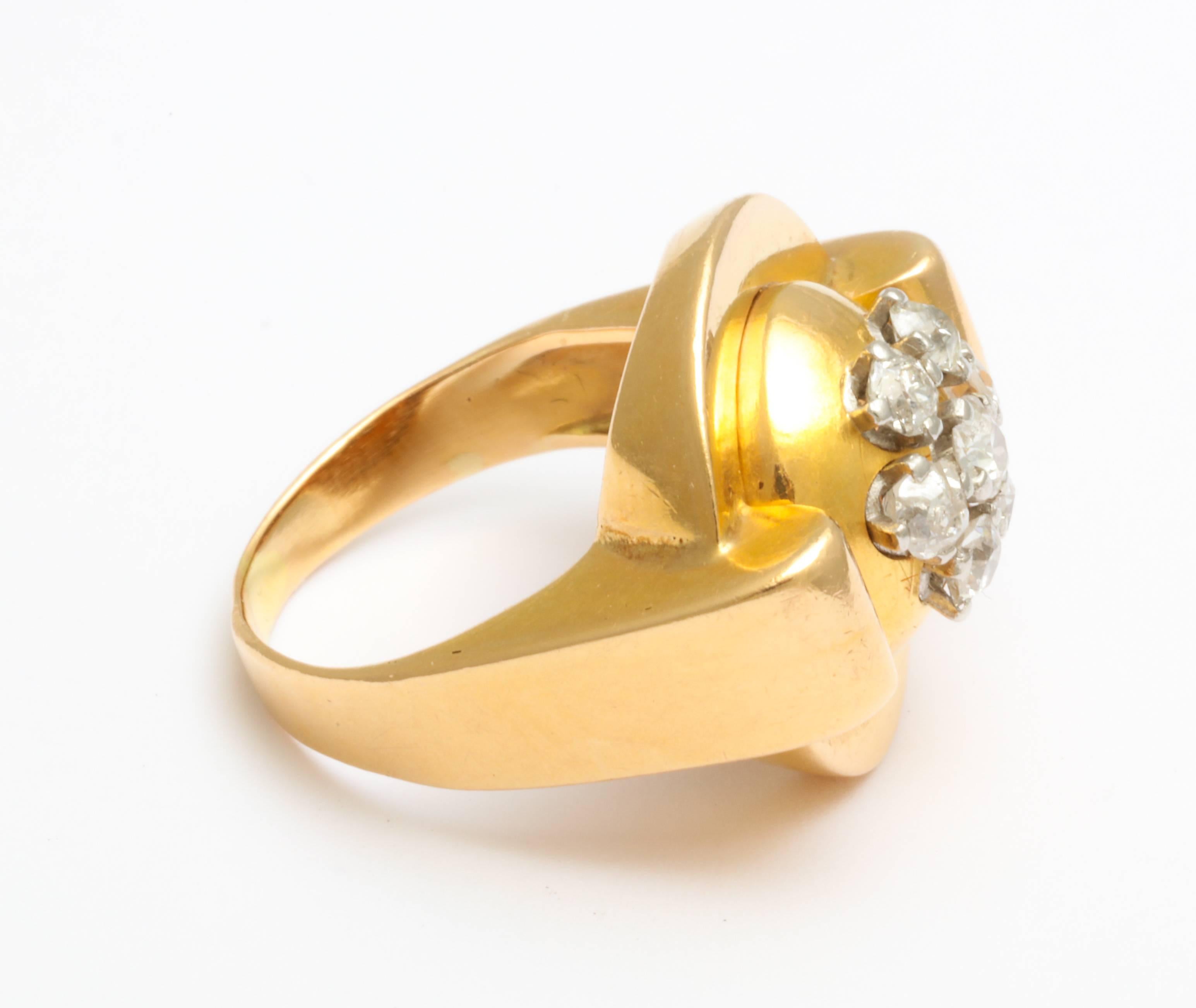 A Classic retro 18-karat French gold ring with a grouping of five mine cut diamonds flanked by buttresses that protect the mounted diamonds and give it a clean modernist look that is very in keeping with today’s fashions.