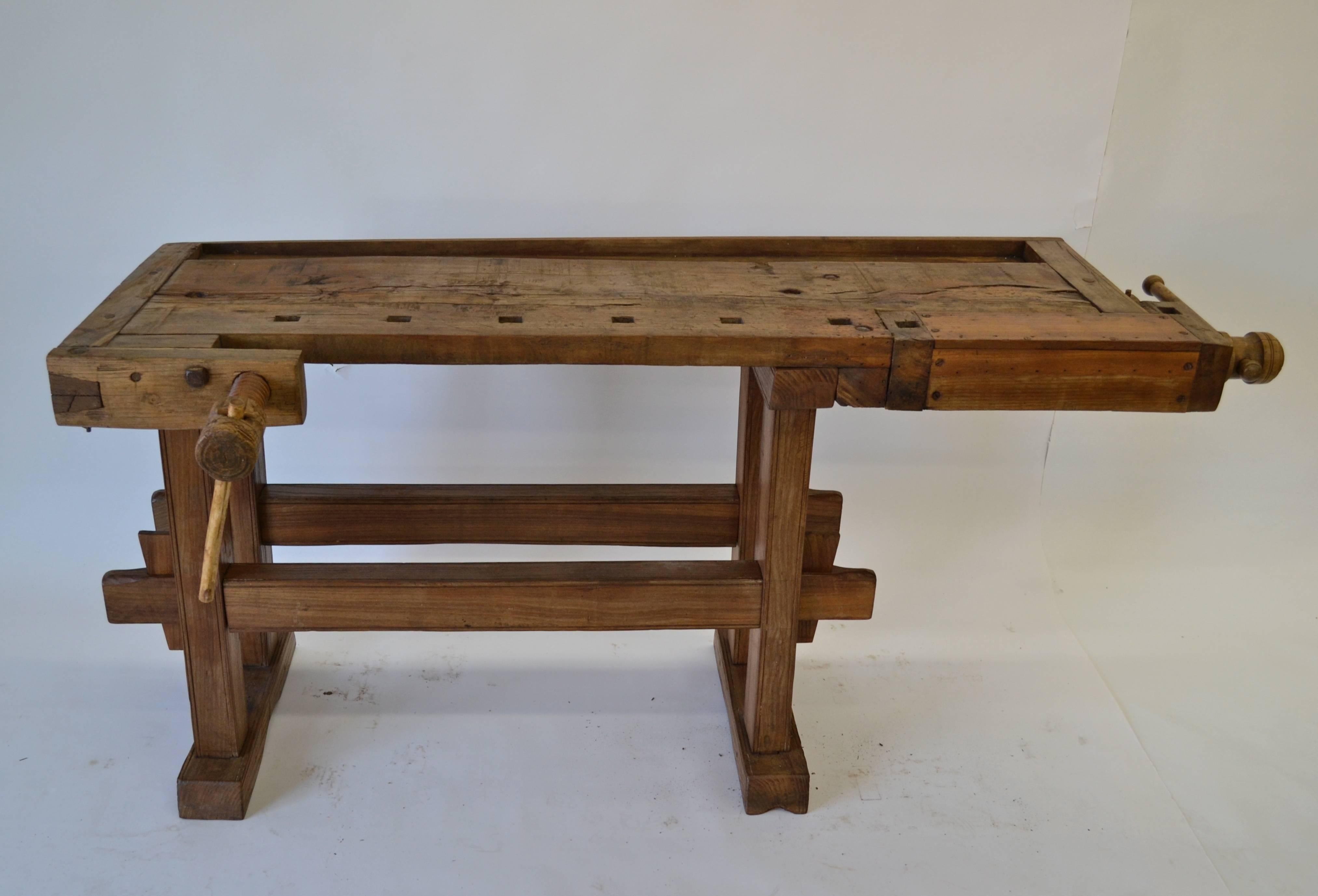 Our workbenches are always good but right now we have some beauties. This one has a 2”oak top with wooden screw turned vises on the front and left hand side. The knock-down base is built to last of 3”by 4” oak posts with incised band decoration, the