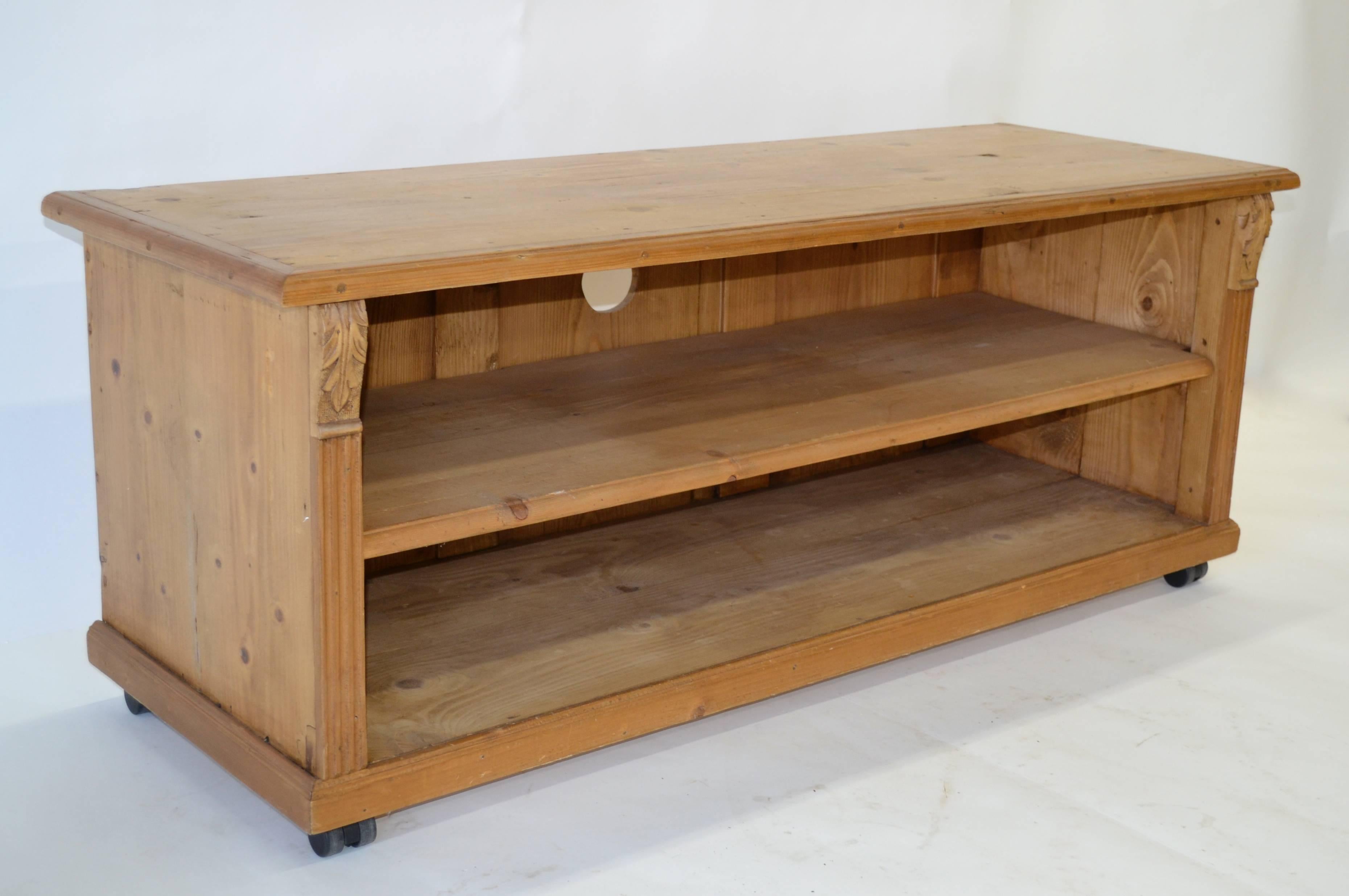 This functional and attractive TV stand is made from the salvaged remains of an ailing vintage armoire and mounted with modern casters for easy moving. The “base” is divided into two compartments for components which are bordered with fluting and