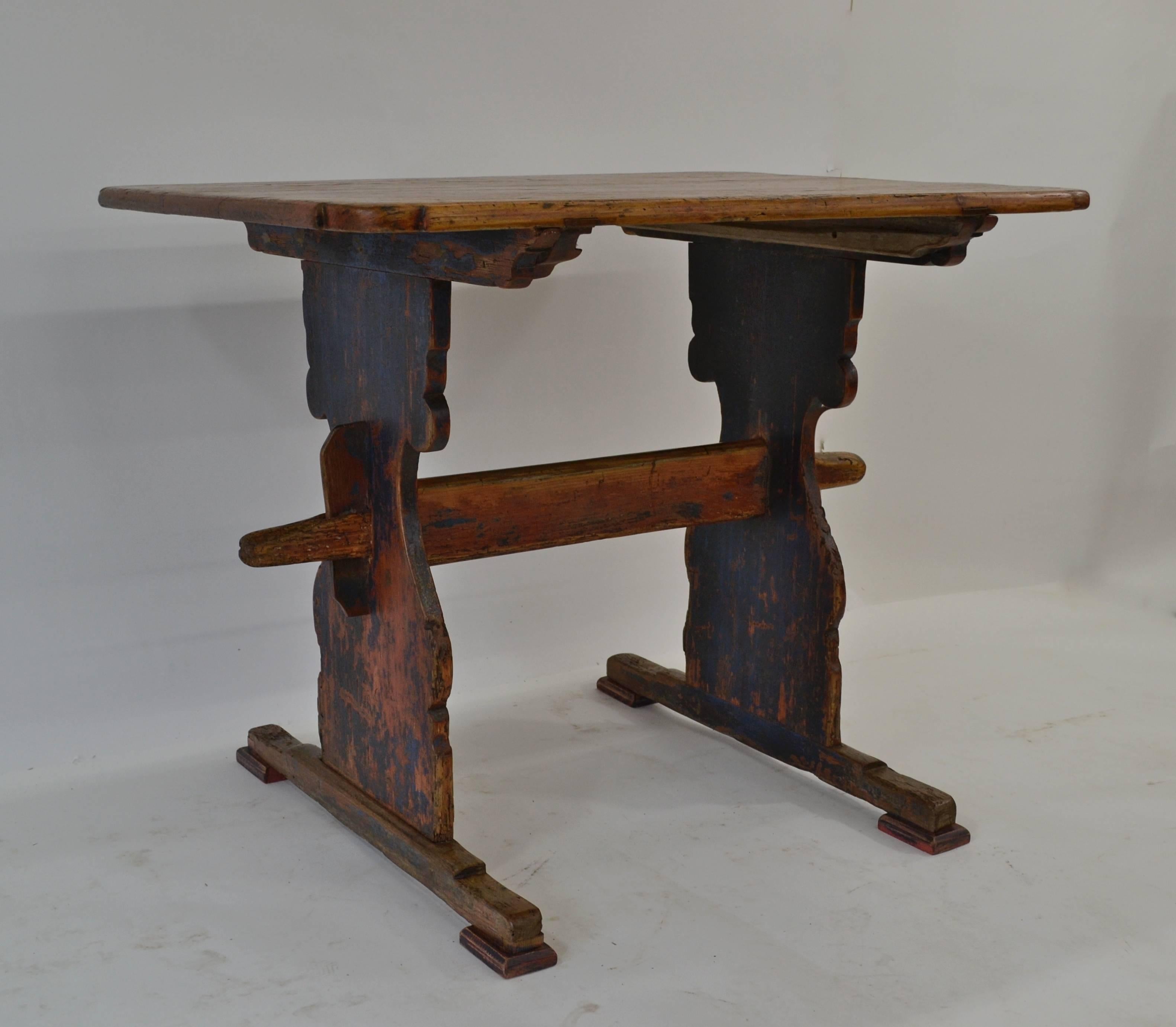 This is a table that brings a smile to your face. From its worn and pitted top with a neatly-executed diamond patch to its curiously sphinx-like feet with replaced rectangular pads, it is a delight to look at, both in appearance and construction.