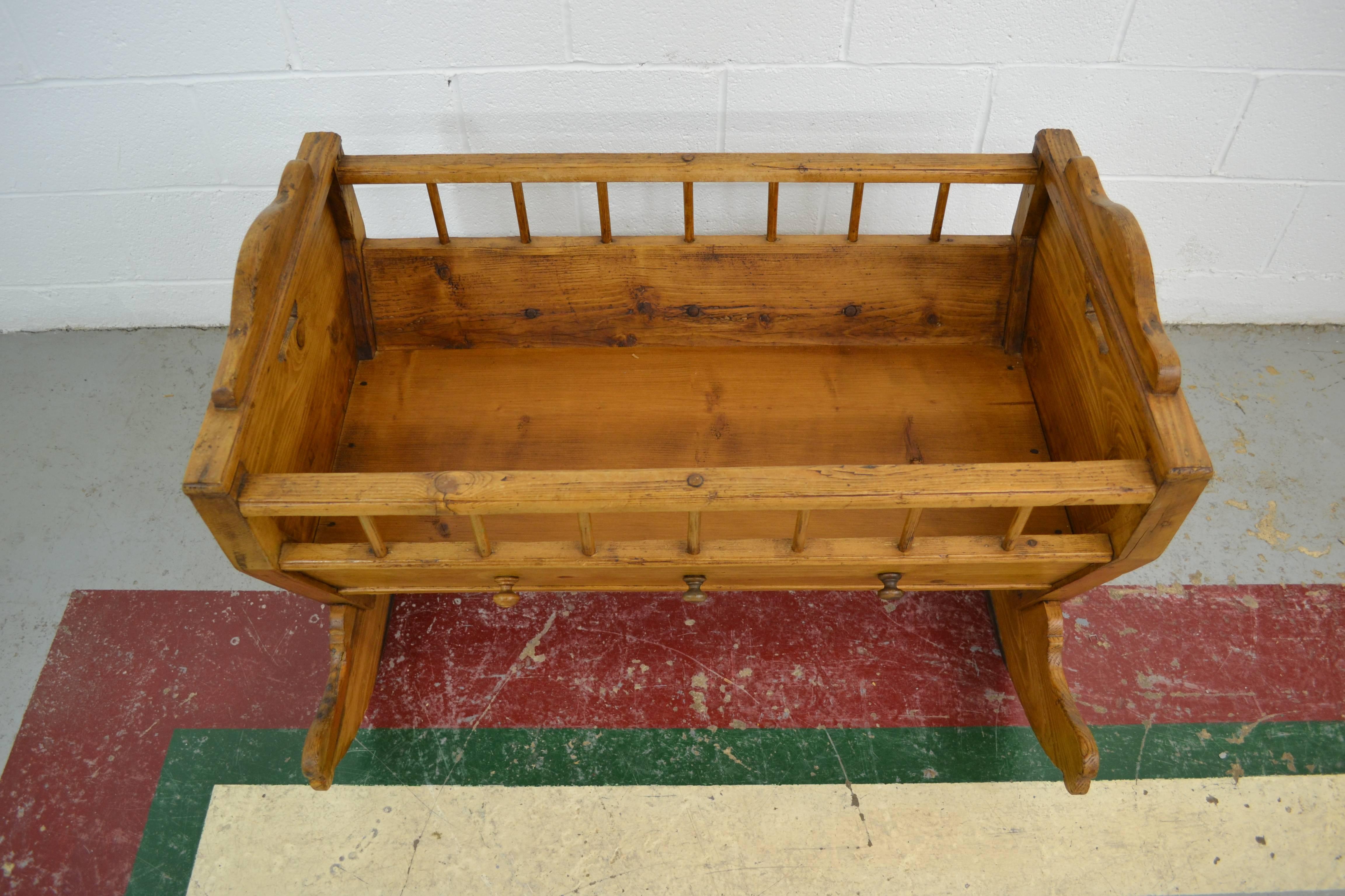 Our three grandsons all spent their early months sleeping in this lovely pine rocking cradle from the Netherlands and now it is time to pass it on to another family. All original except for the base board, this sturdy little piece rocks smoothly on