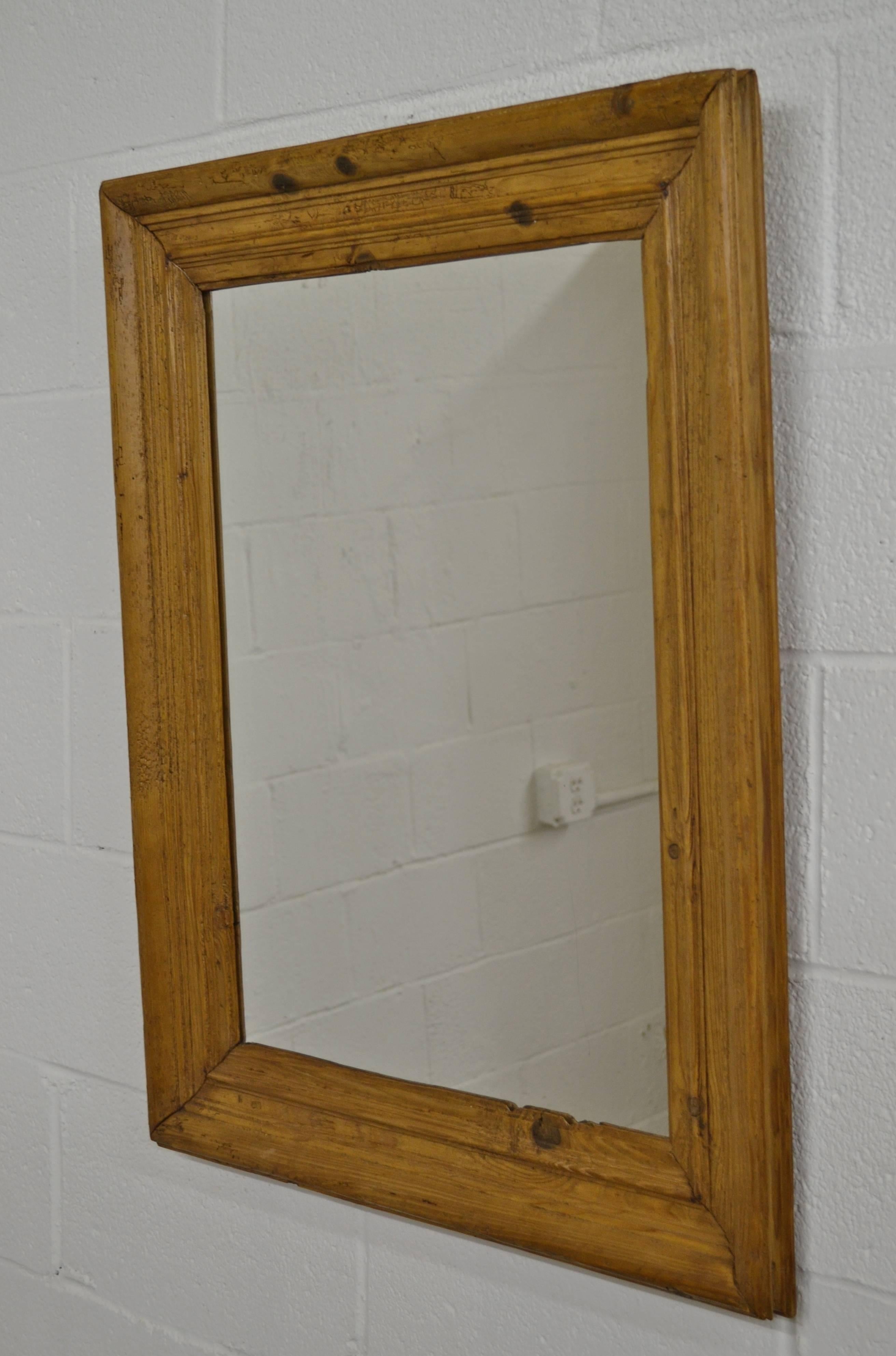 A delightfully rustic antique pine picture frame fitted with new mirror glass. Frame molding is 4.5