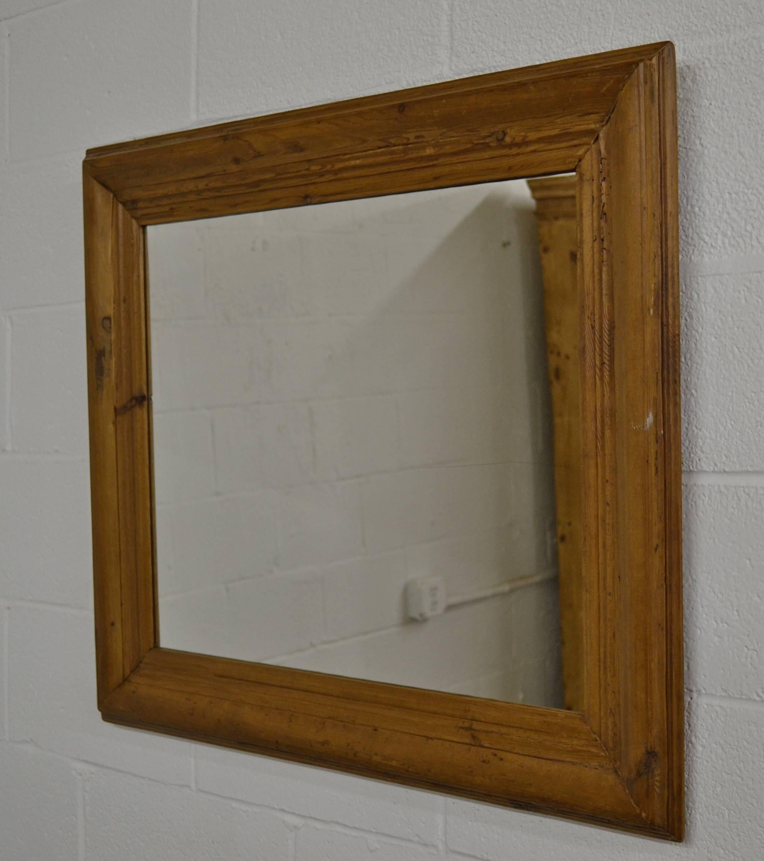 A beautifully naturally aged and polished pine picture frame fitted with new mirror glass. Frame molding is 4