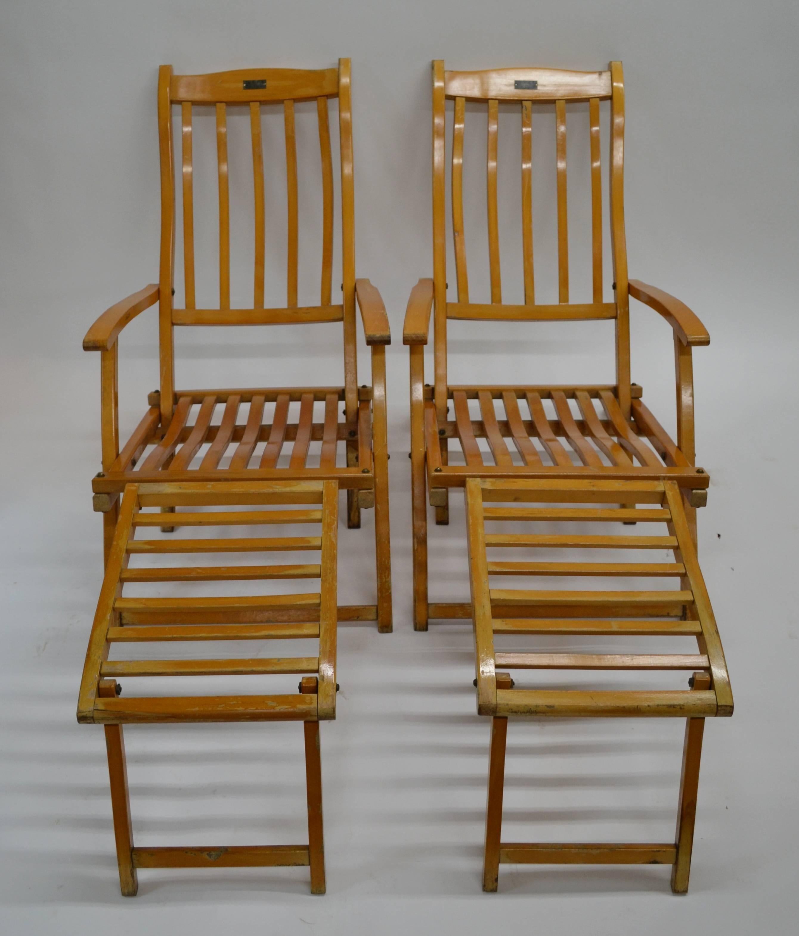 A fine pair of vintage folding hardwood ocean liner deck chairs with original fitted cushions. Each chair bears a metal plate on the top rail with the words “RMS Queen Elizabeth”. We are uncertain if these deck chairs are actually from the Queen