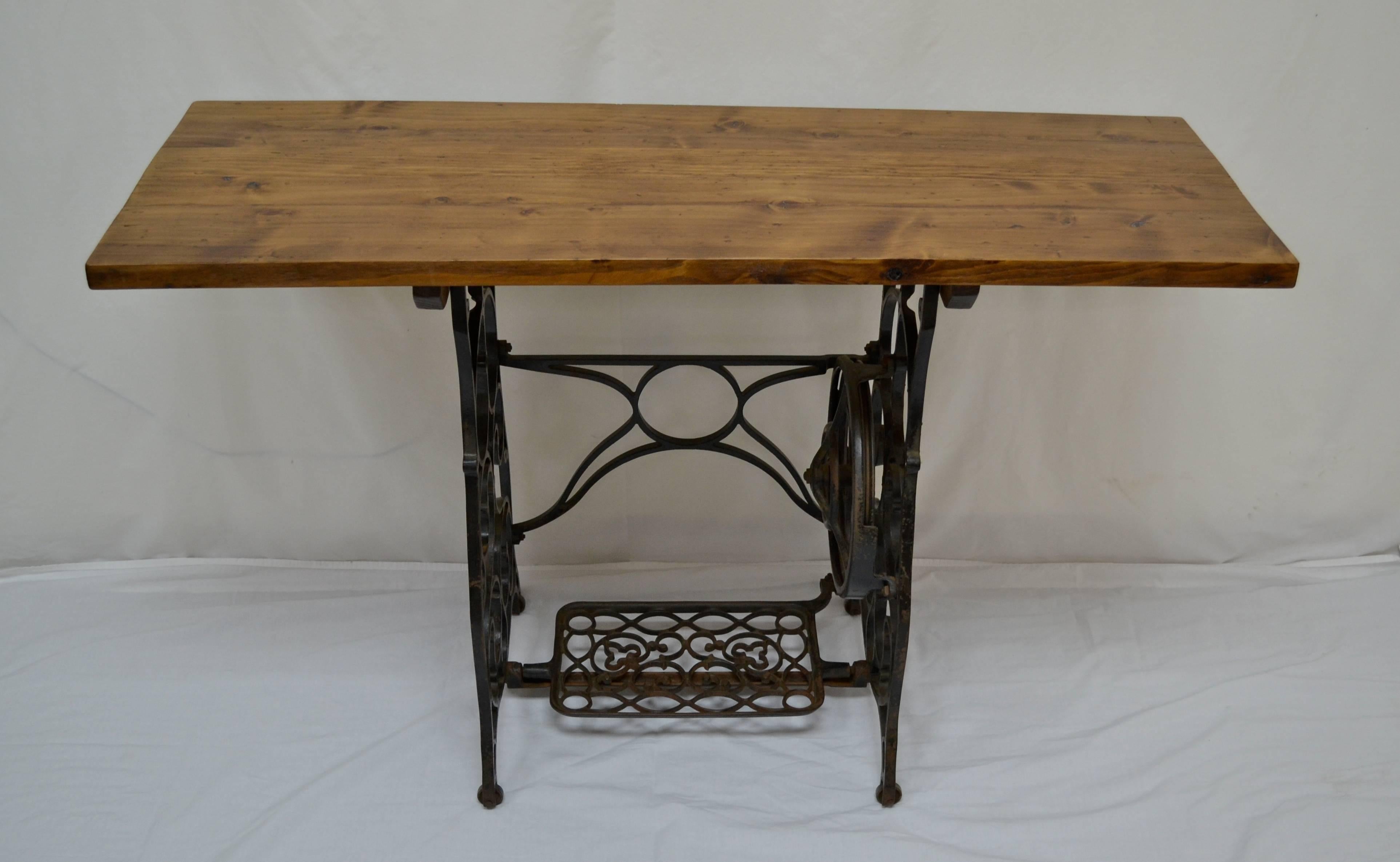 A sears “Franklin” sewing machine from circa 1910 once sat upon this handsome treadle base. We took some reclaimed pine of about the same age and married them to create this Industrial-style side table. Its shallow depth makes this piece perfect for