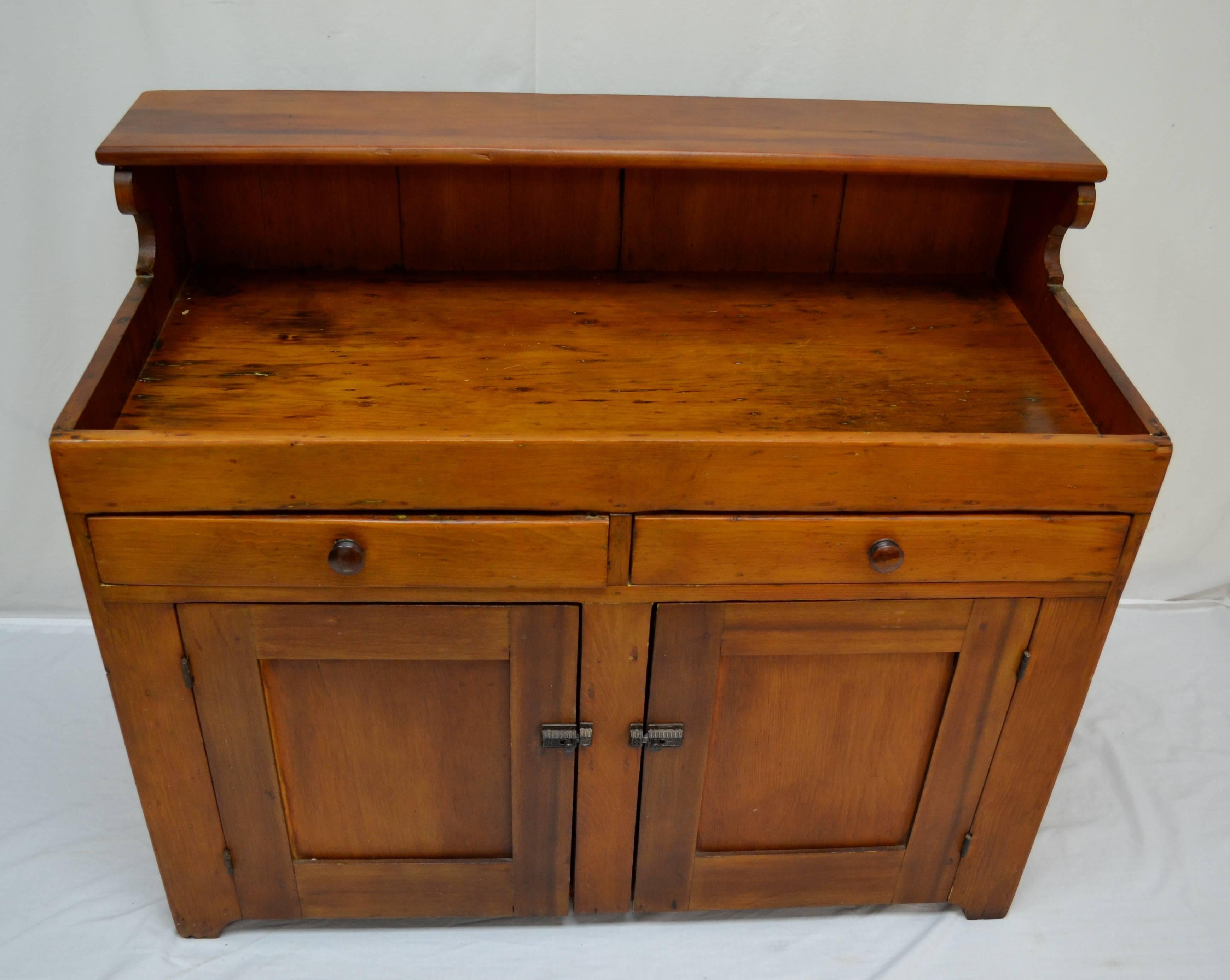 This is a small and well-used dry sink with two lap-jointed drawers and two flat panelled doors with original spring-loaded catches (slightly re-aligned), closing onto a central stile. The doors open 180 degrees, giving easy access to the generous