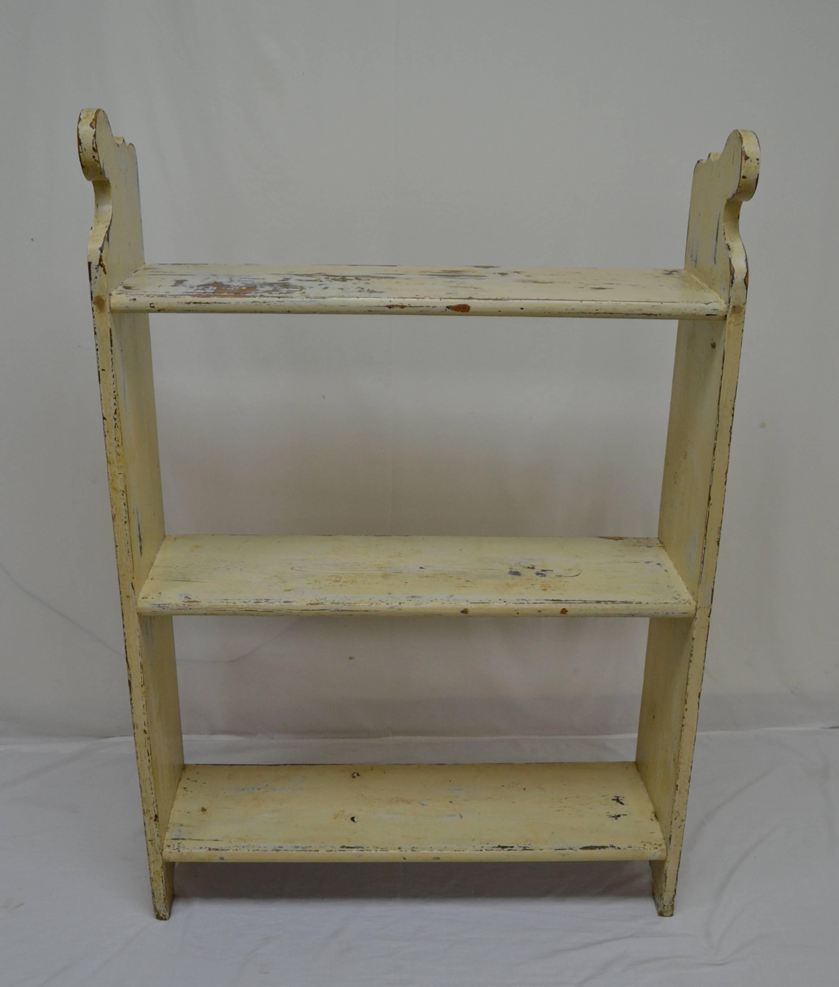 A sturdy pine three shelf unit with a sphinx-like curve to the top of the thick sides. The top and bottom shelves are through-tenoned into the sides and the middle shelf is dovetail mortised, for strength and stability. With shelves a true inch