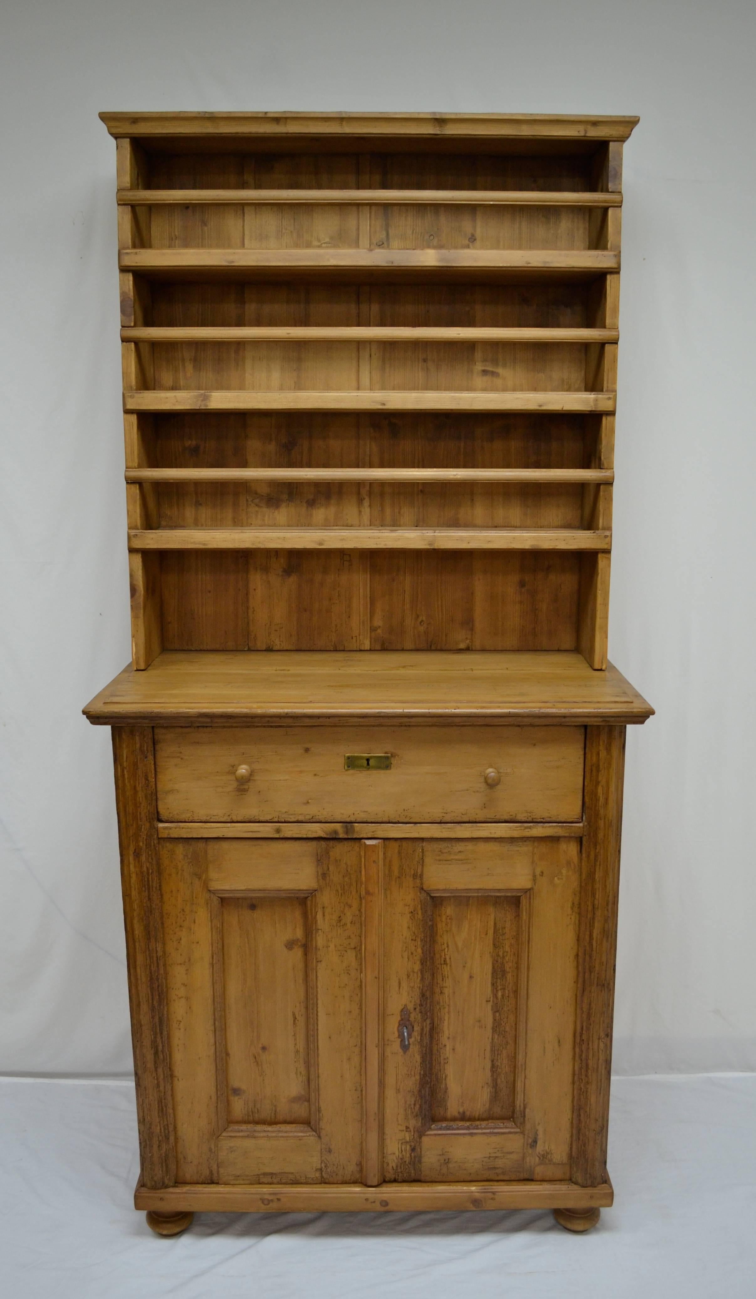 This tall and narrow pine open rack dresser is a marriage; that is, the pieces were not built to go together; but it is one made long ago and the pair are very compatible. The base has a single full-width hand-cut dovetailed drawer above two doors