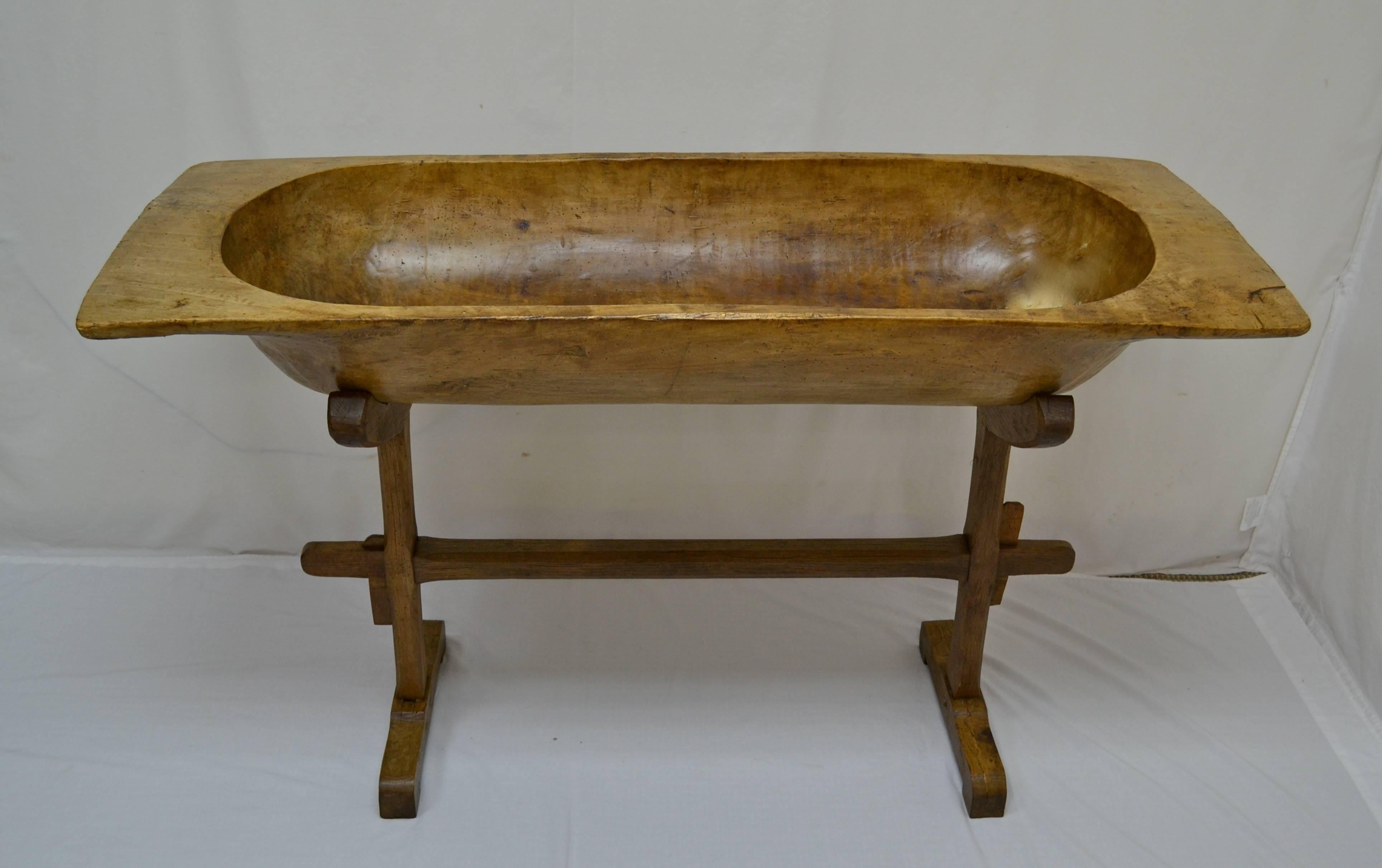 Used for multi-family baking, this huge fruitwood trog was hand-crafted from a single split log, its rich rugger brown colour showing off the tool marks on its hand-hewn interior.  It has one or two superficial cracks, some inactive woodworm holes