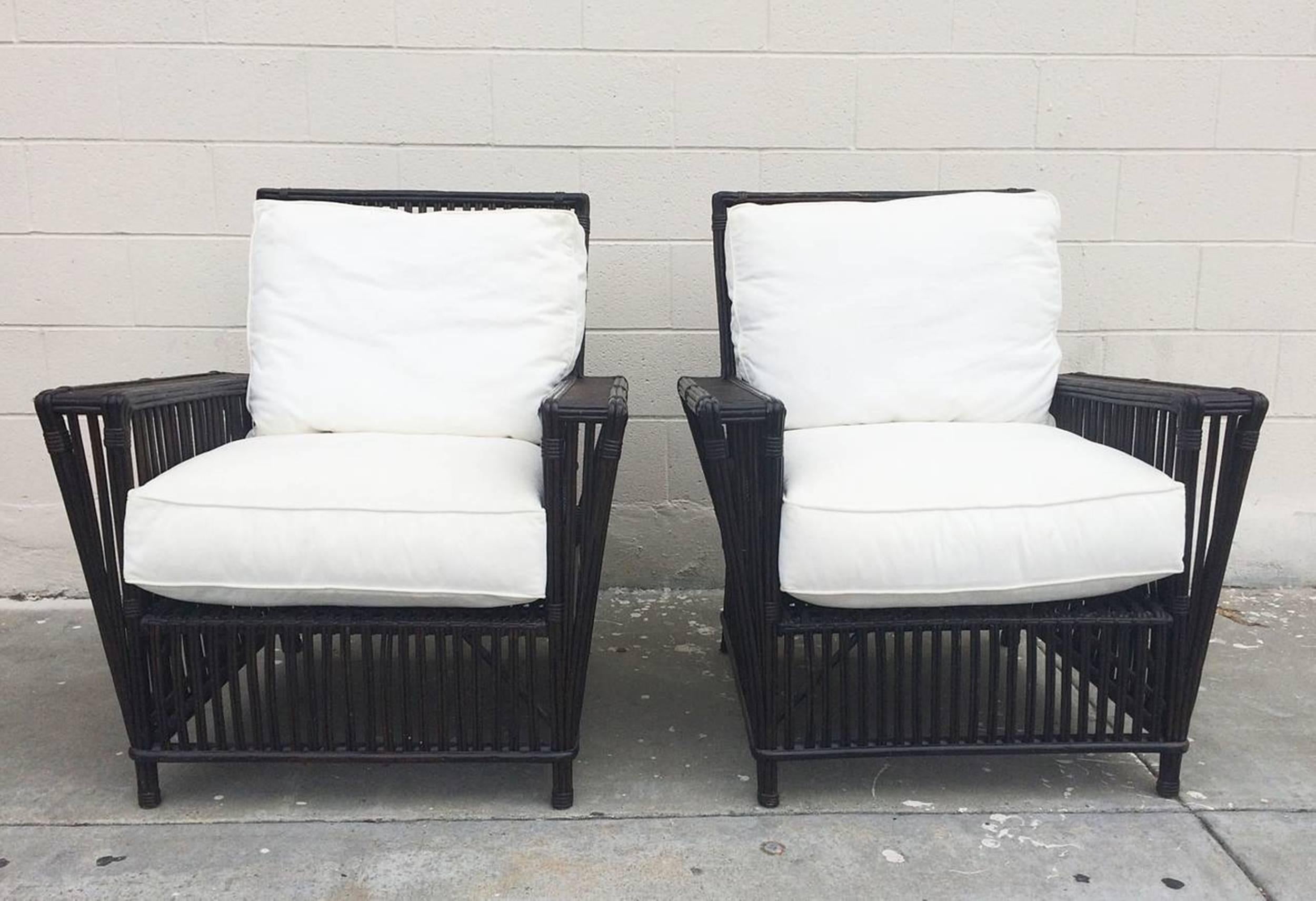 Beautiful pair of patio chairs made out of wicker or bamboo reeds and upholstered in white canvas fabric.
The chairs are in excellent condition, the seats can be upholstered in COM or COL at no additional charge.

The chairs have great lines,