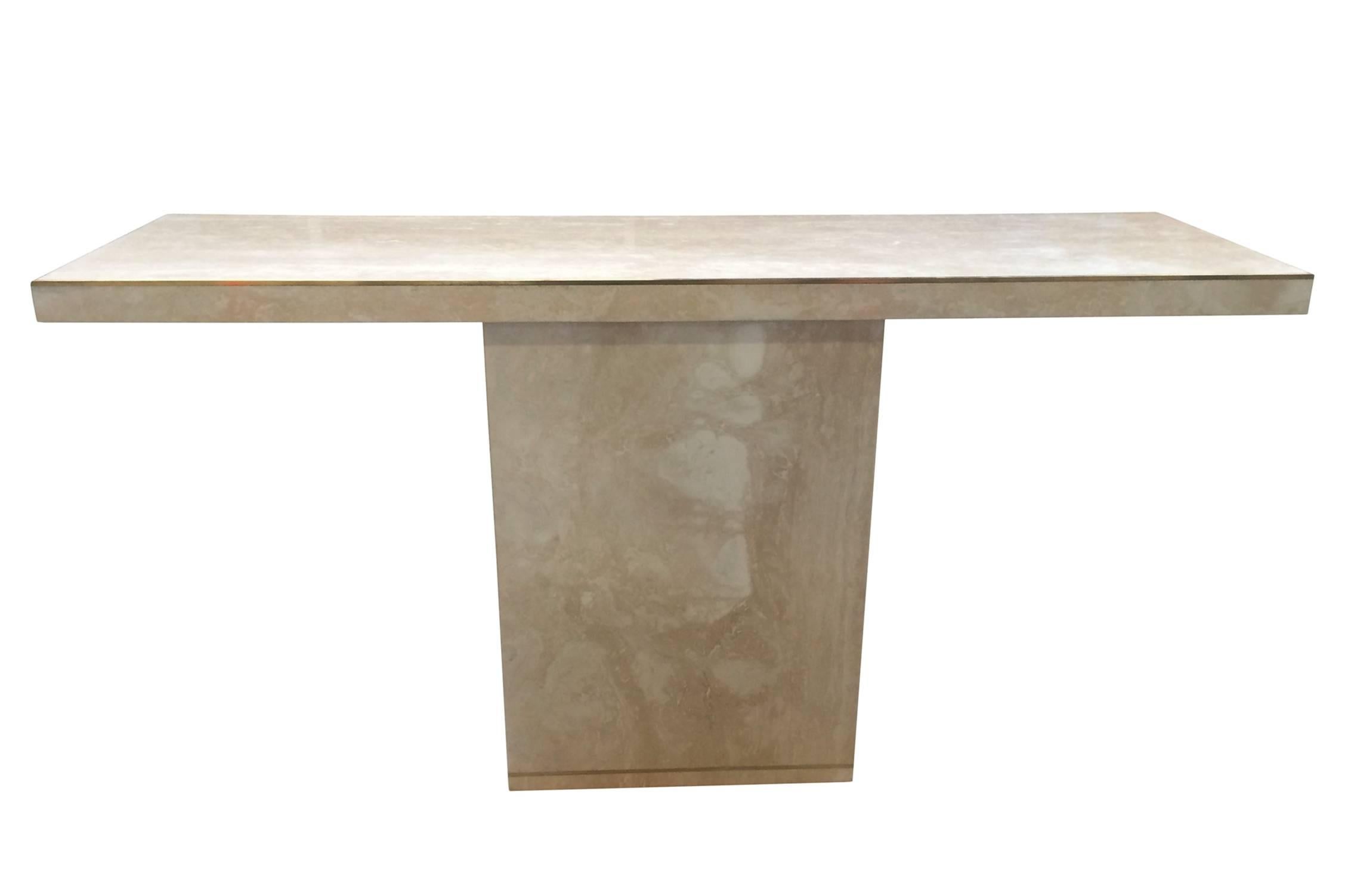 Stunning travertine and brass console designed and manufactured by Cain modern.

The travertine surface is absolutely breathtaking and the brass inlaid along the edges makes the piece really stand out.
The table is made to order and we can