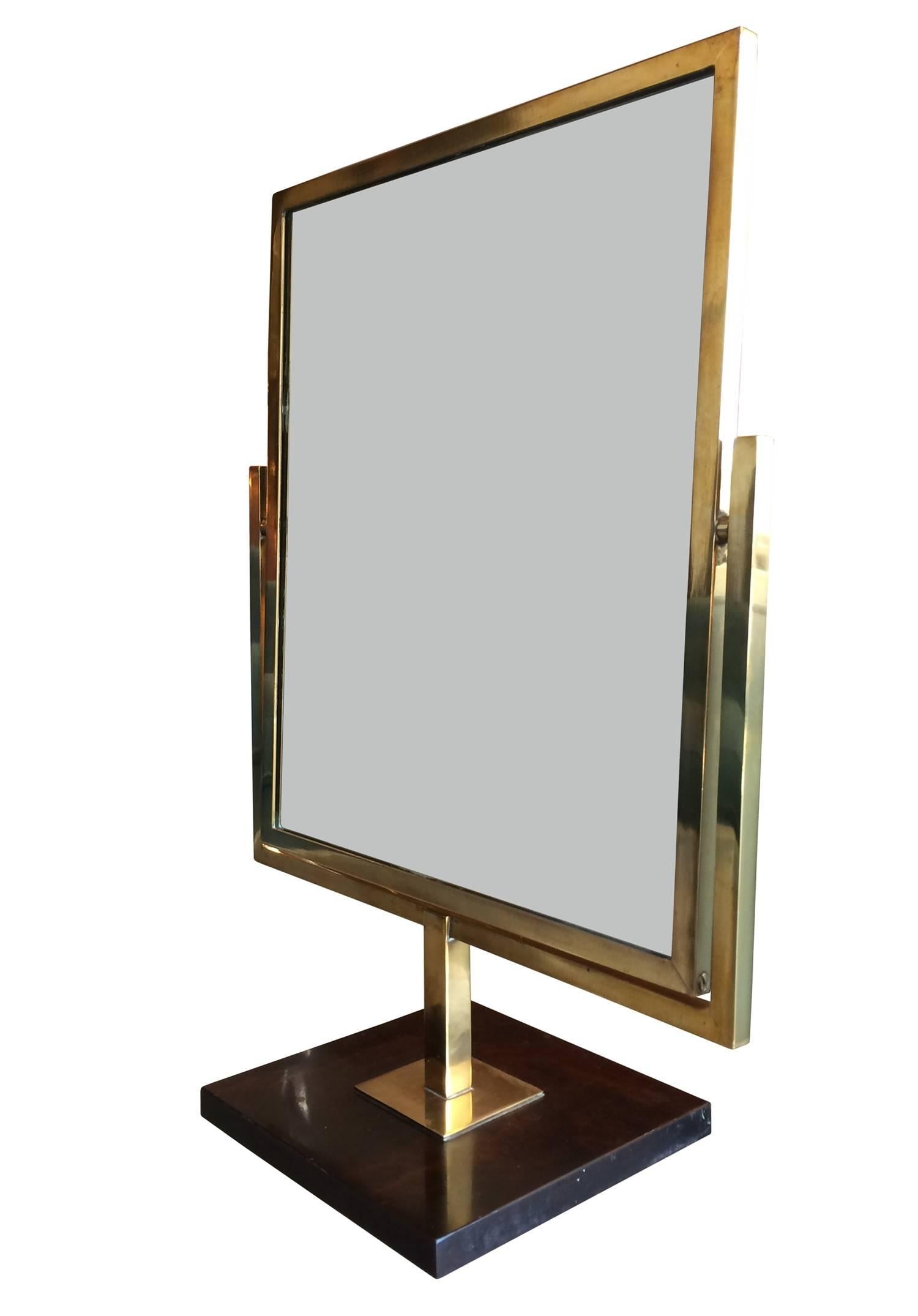 Beautiful double sided mirror in brass and burl wood designed and manufactured by Charles Hollis Jones.
The brass shows a nice aged patina and the burl wood base has a nice lacquered finish to it.
The mirror can be used from either side and it