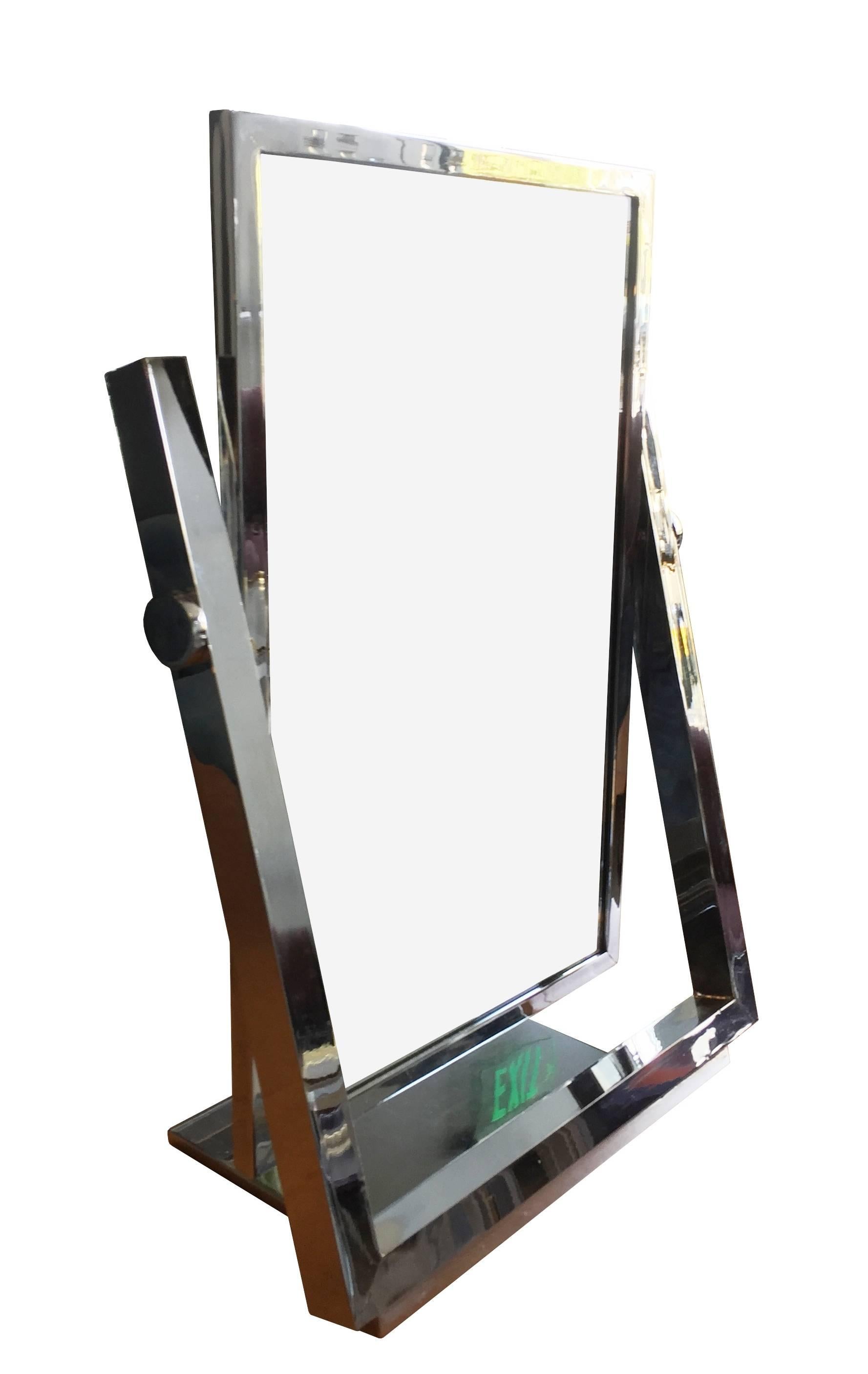 Fantastic and rare vanity mirror in chrome design and manufactured by Charles Hollis Jones in the 1970s.
The piece is beautiful designed and crafted, the mirror swings back and forth and is double sided so that it can be used on either side.

The