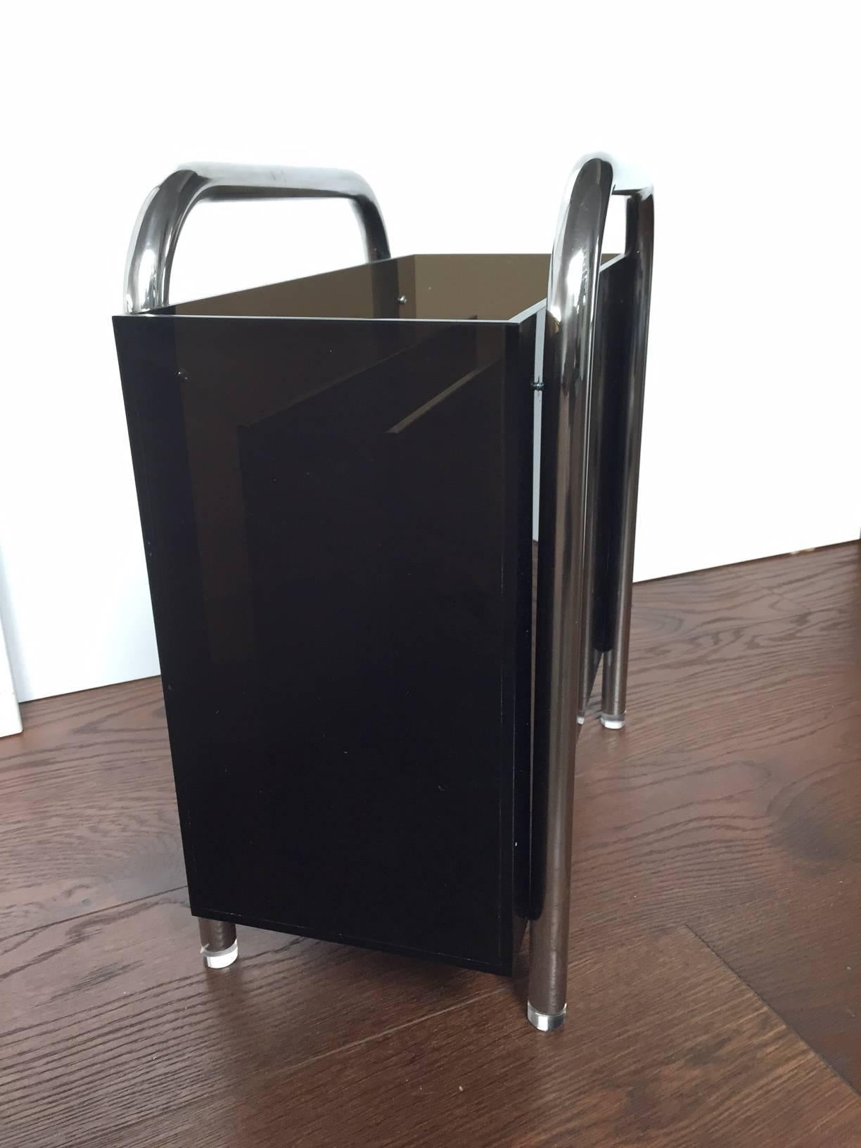 Beautiful and rare magazine holder designed and manufactured by Charles Hollis Jones in the 1970s.

The piece is executed in bronzed Lucite having a solid stainless steel frame having three compartments to store books or magazines.

The piece is