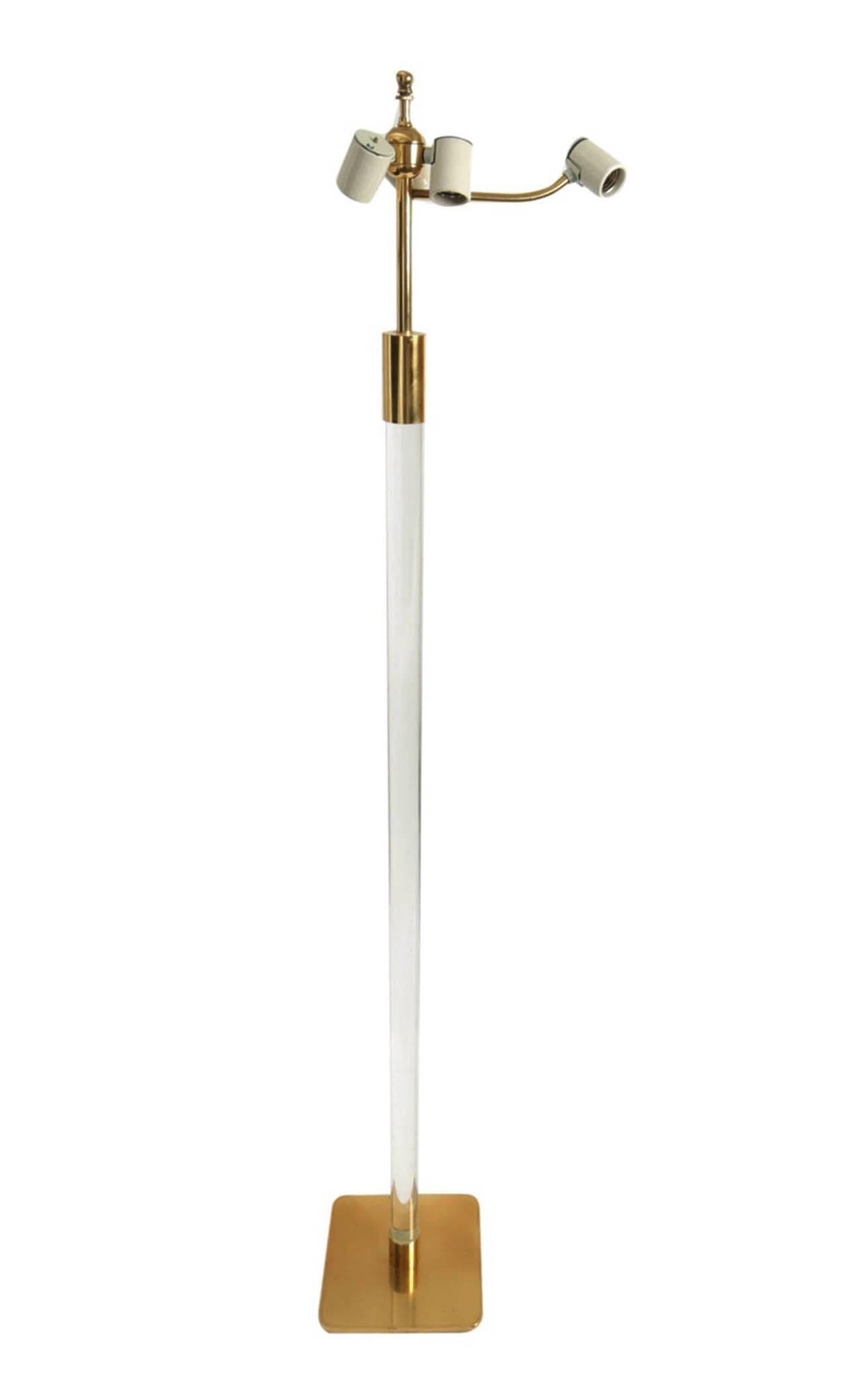 Solid Lucite pole floor lamp by Hansen of New York, circa 1970.
Golden brass hardware and base with a thick Lucite stem. The piece is stamped "Hansen Lamps New York" on bottom of the base.
(Shade not original and used for photos only,