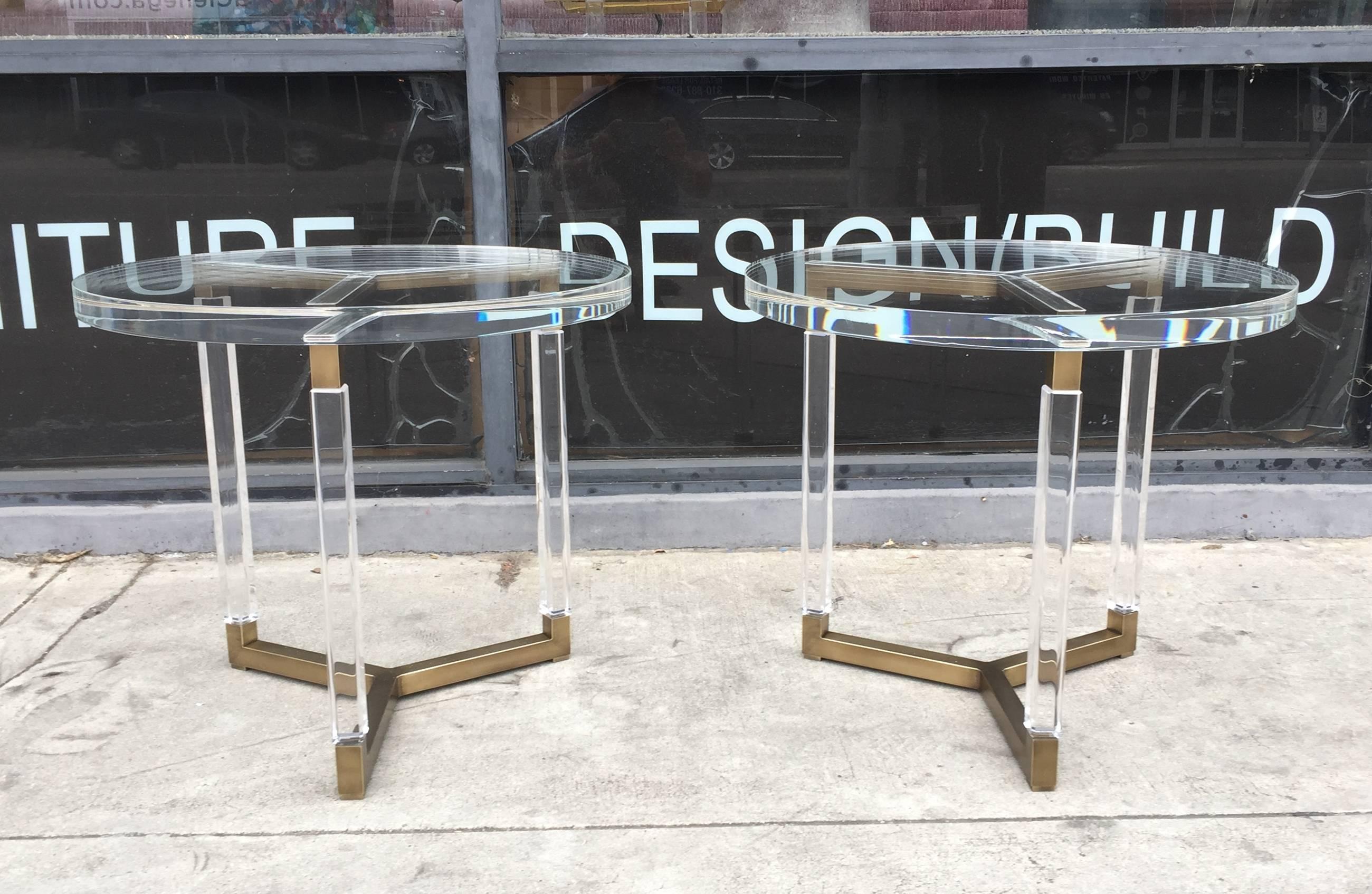 Beautiful set of side tables in solid brass and Lucite designed and manufactured in the 1960s by Charles Hollis Jones as part of his Metric collection.

The tables are in very good condition, the Lucite is free of chips, crazing or clouding and