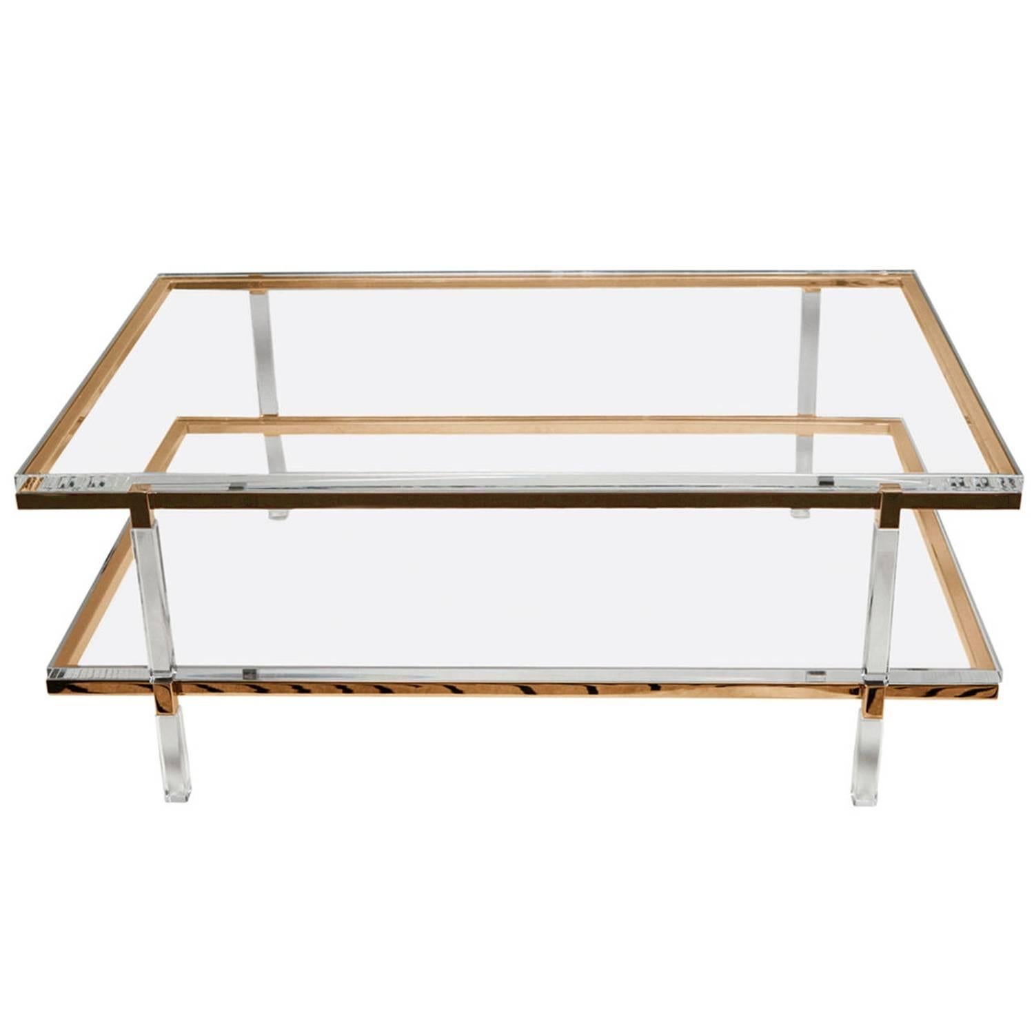 Two level coffee or cocktail table designed and manufactured by the icon of Lucite Charles Hollis Jones as part of the Metric collection designed in the 1960s.

The table is executed in Lucite and polished brass topped with a 1 1/4