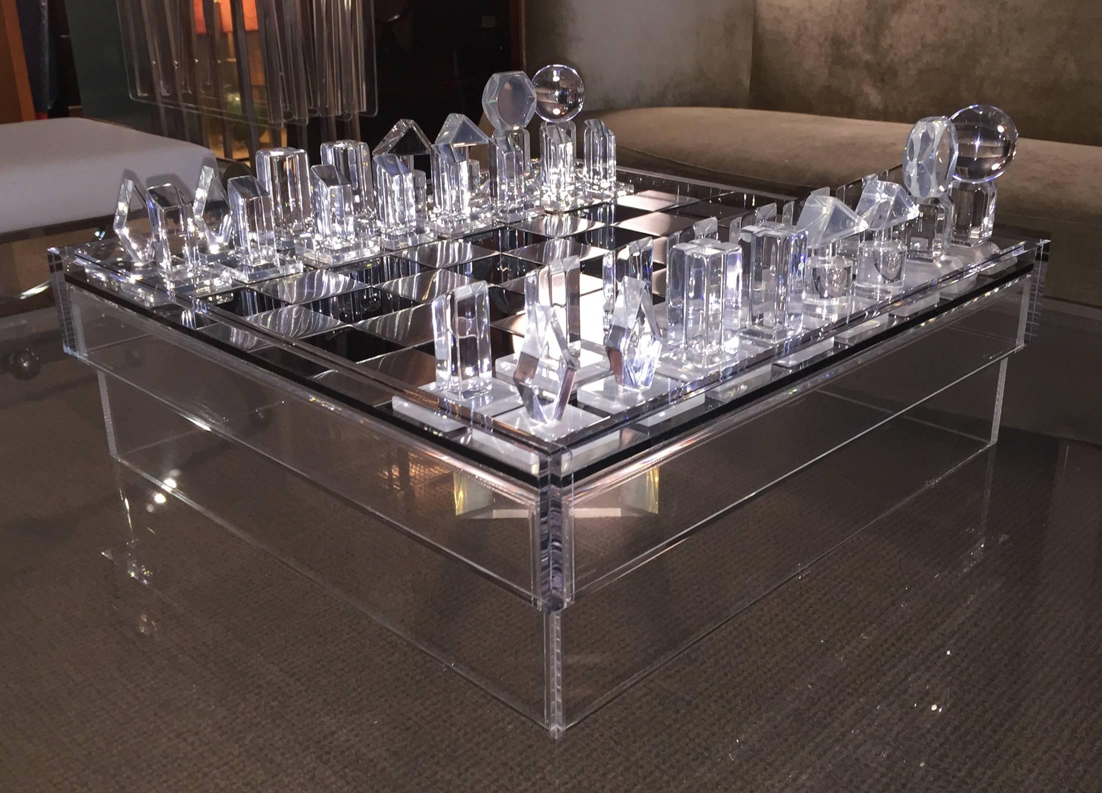 Beautiful Lucite and aluminum chess set designed and manufactured in the 1970s.
The set is very well designed, the chess board is raised and is made from a combination of aluminum, smoked and clear Lucite, all of the chess pieces are made out of