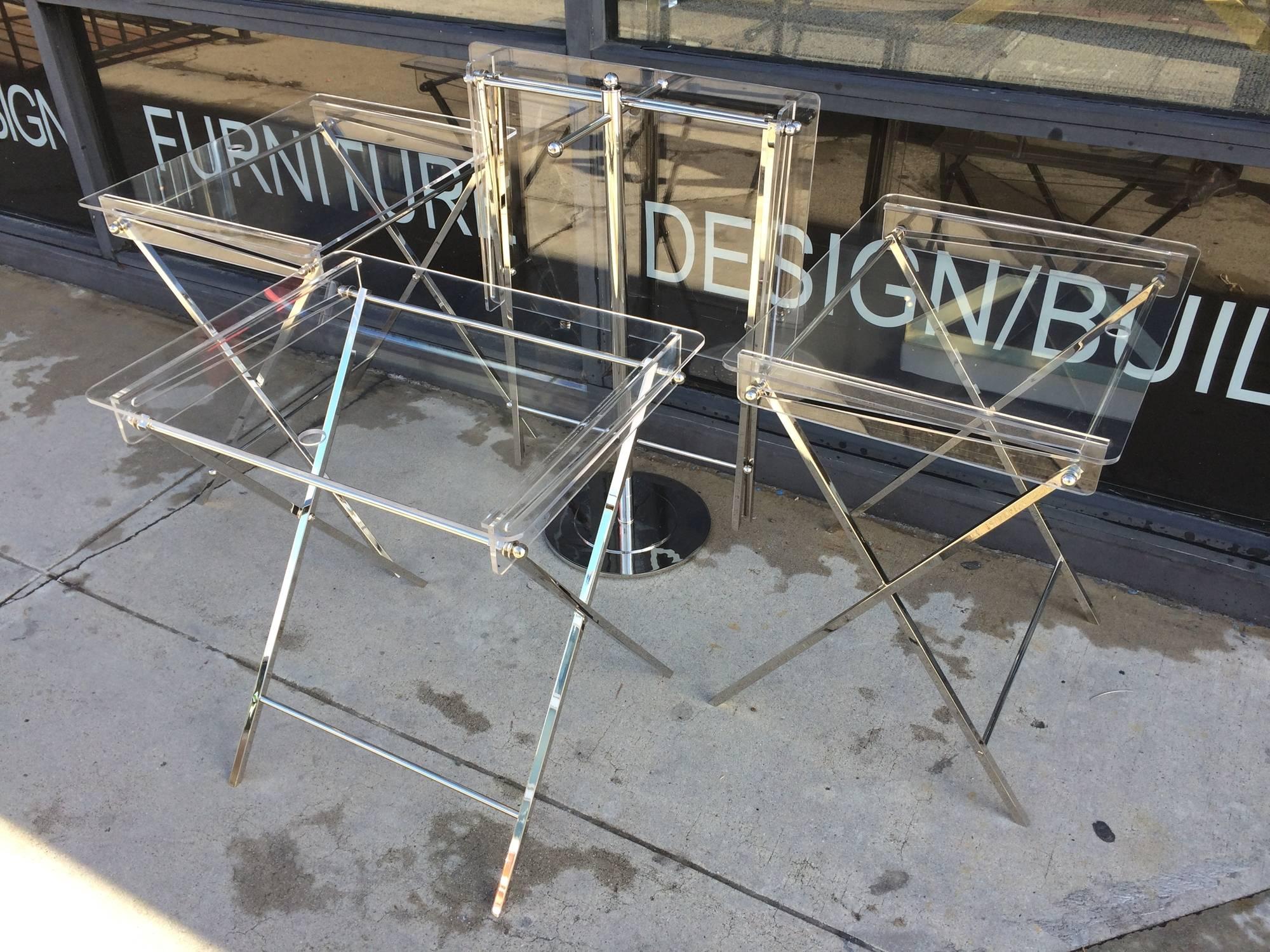 Beautiful set of four clear Lucite serving trays and stand designed by Charles Hollis Jones for Lucille Ball and part of the 