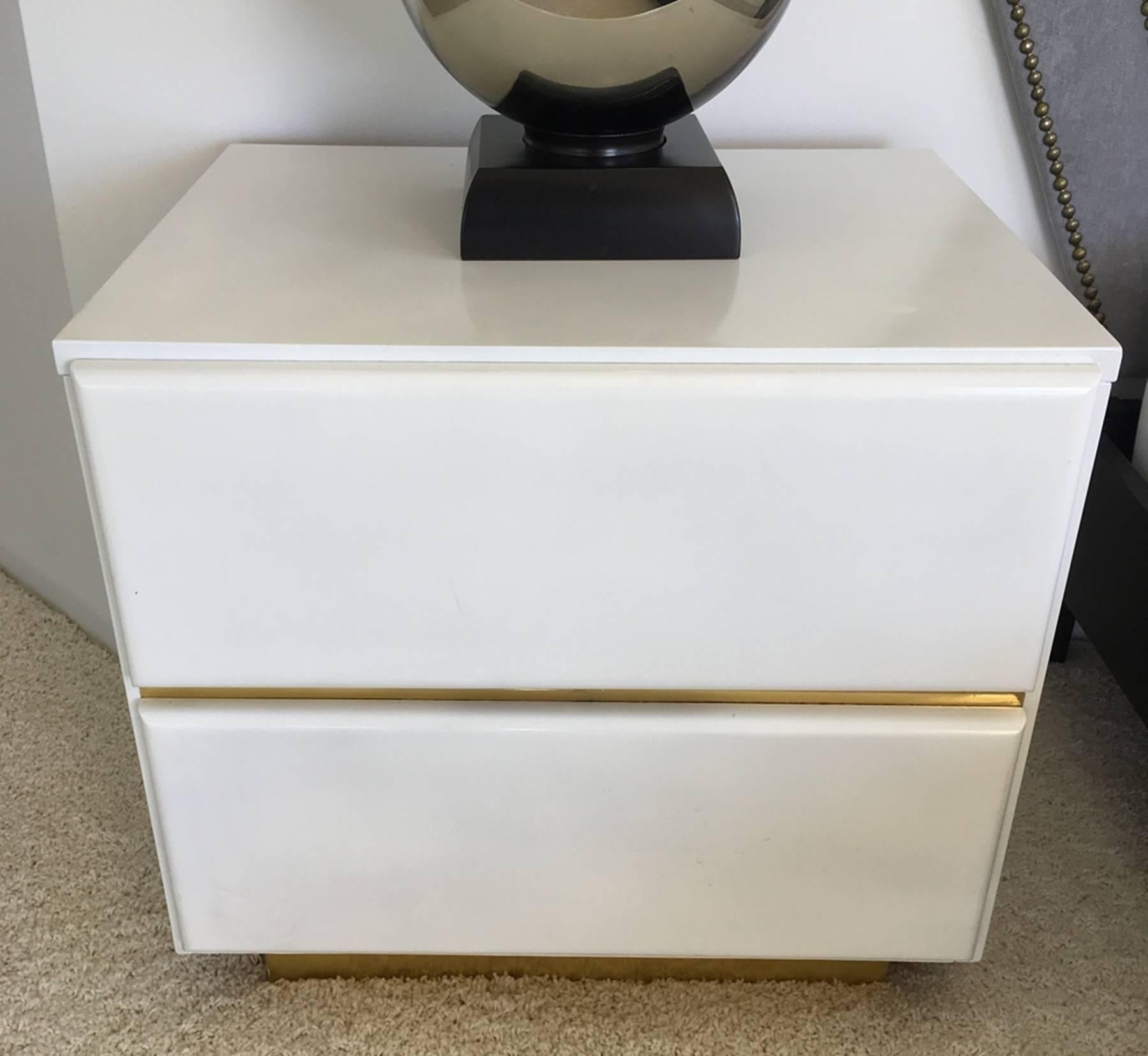 Beautiful pair of nightstand designed and manufactured by Lane Furniture and has a modern 1980s look. The nightstands comes with two drawers and brass trim around the bottom and between the drawers. 

Measurements:
24.0ʺ wide × 16.0ʺ deep × 20.0ʺ