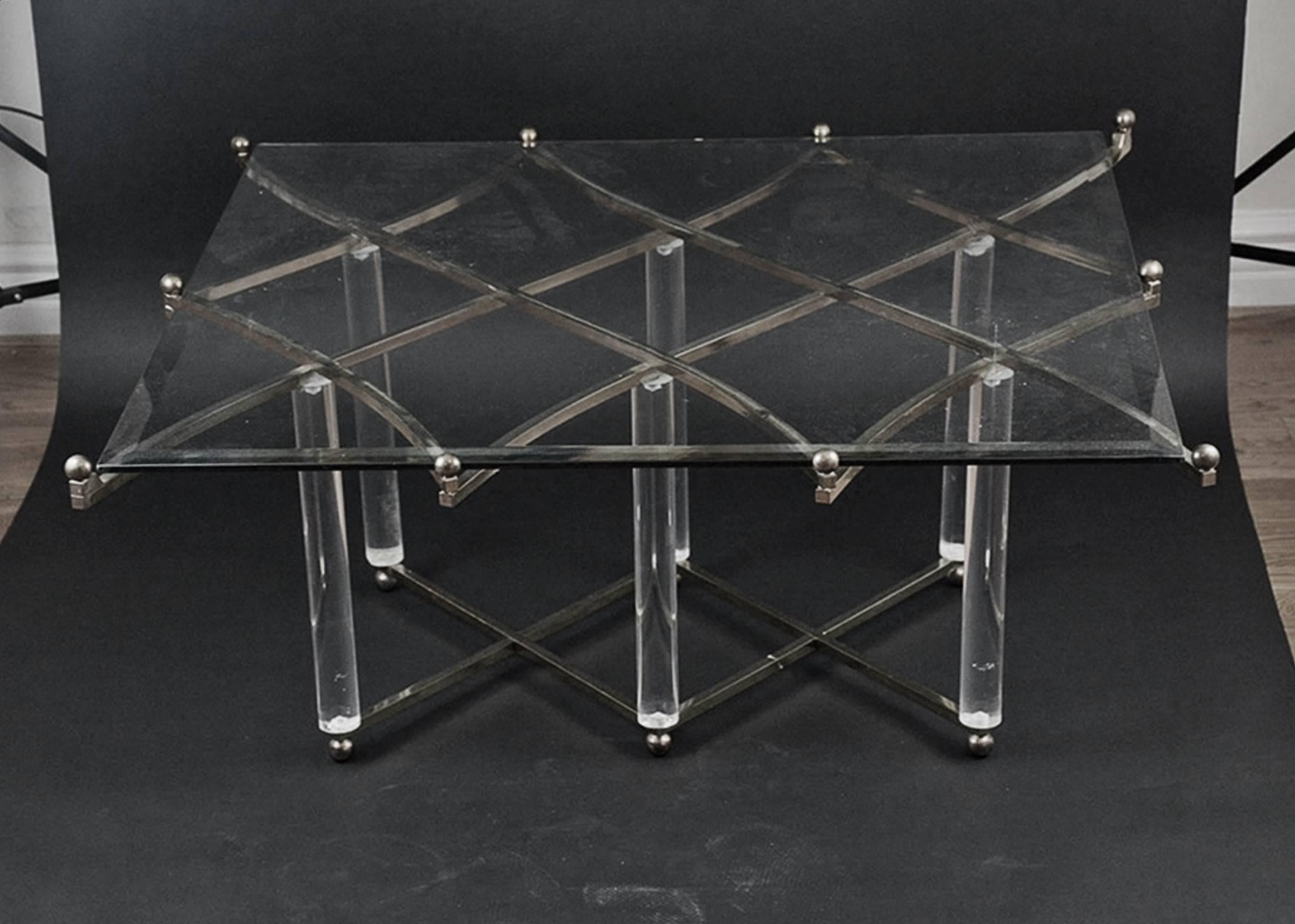 This amazing polished nickel and Lucite coffee table by Hollis Jones is quite possibly his most exquisite design. 
Known for his innovation with the use of Lucite and metal, Hollis Jone is a master at combining elegance and wit. The lattice work of