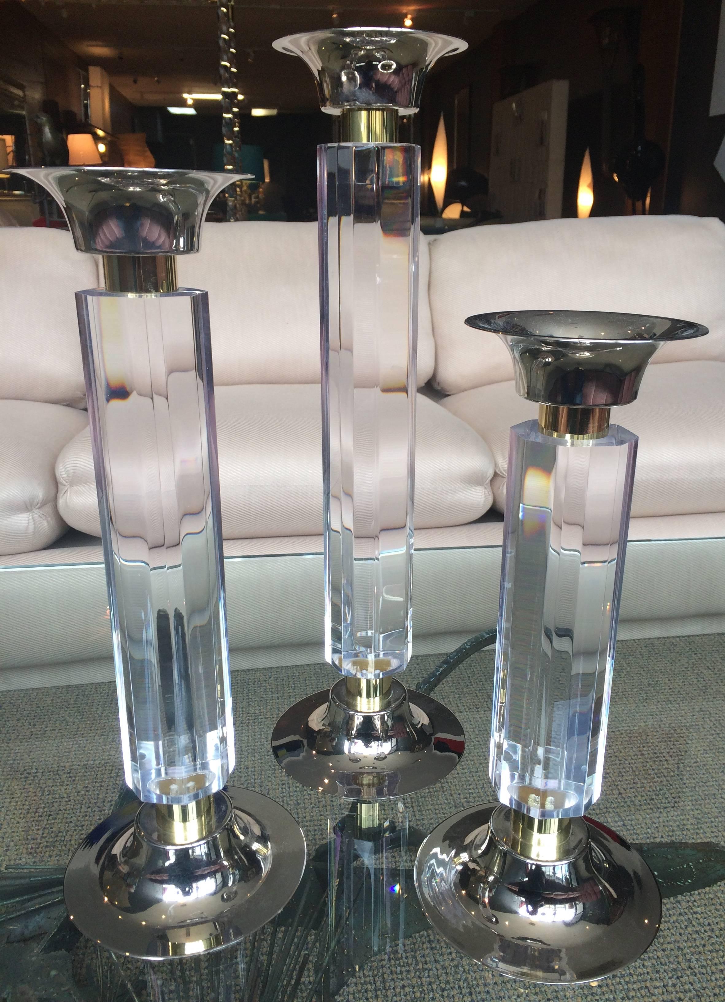 Stunning set of three large candleholders in Lucite brass and nickel bases designed and manufactured by Amparo Calderon Tapia for Cain Modern.

The pieces are very large and imposing, the Lucite has an octagonal shape an it is 2 3/4