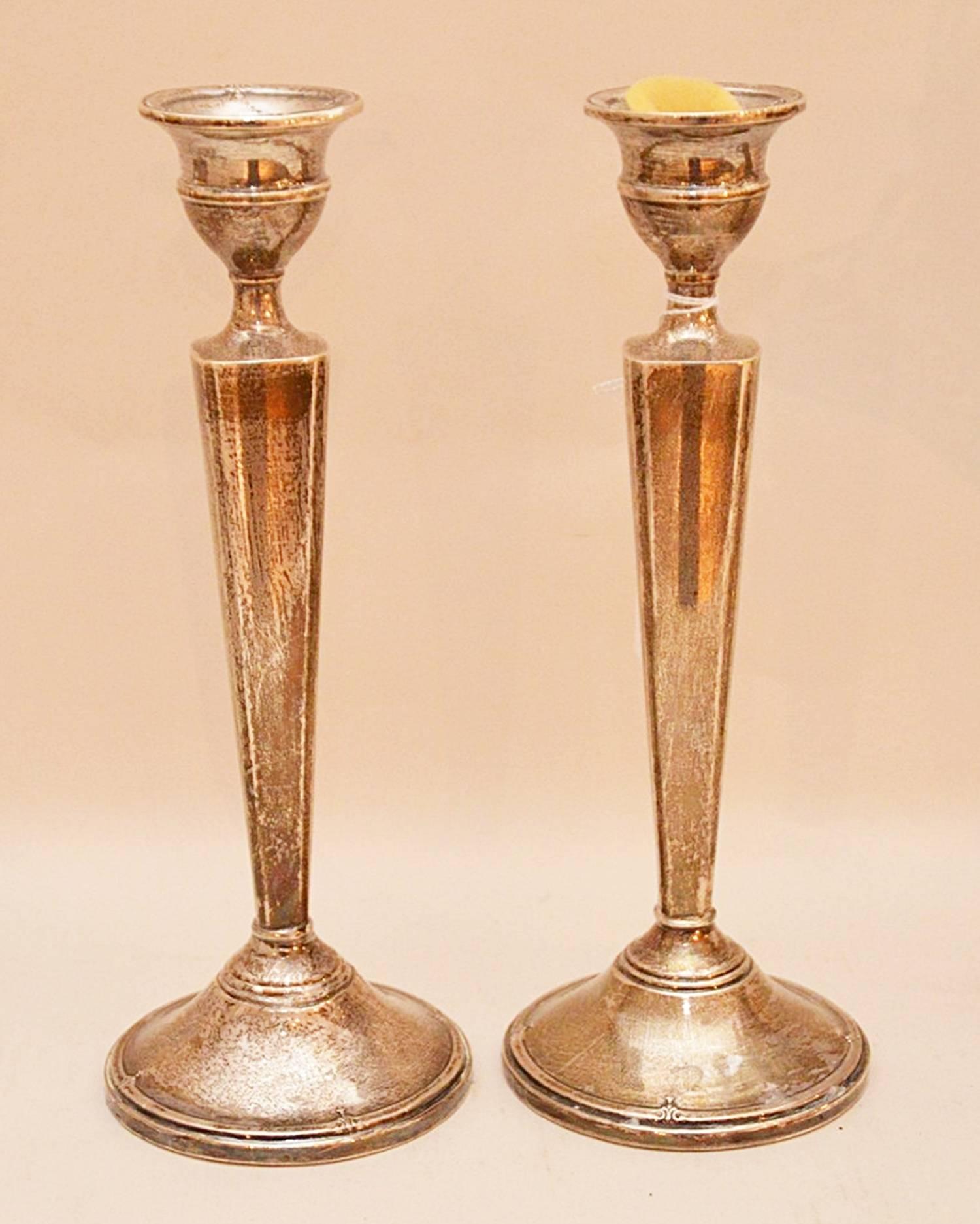 Each elongated tapering standard supporting urn-form candle cup, resting on a stepped circular base, each weighted and marked.

The candlesticks are in good condition and need to be polished.

 If you are coming to our show room to see a piece