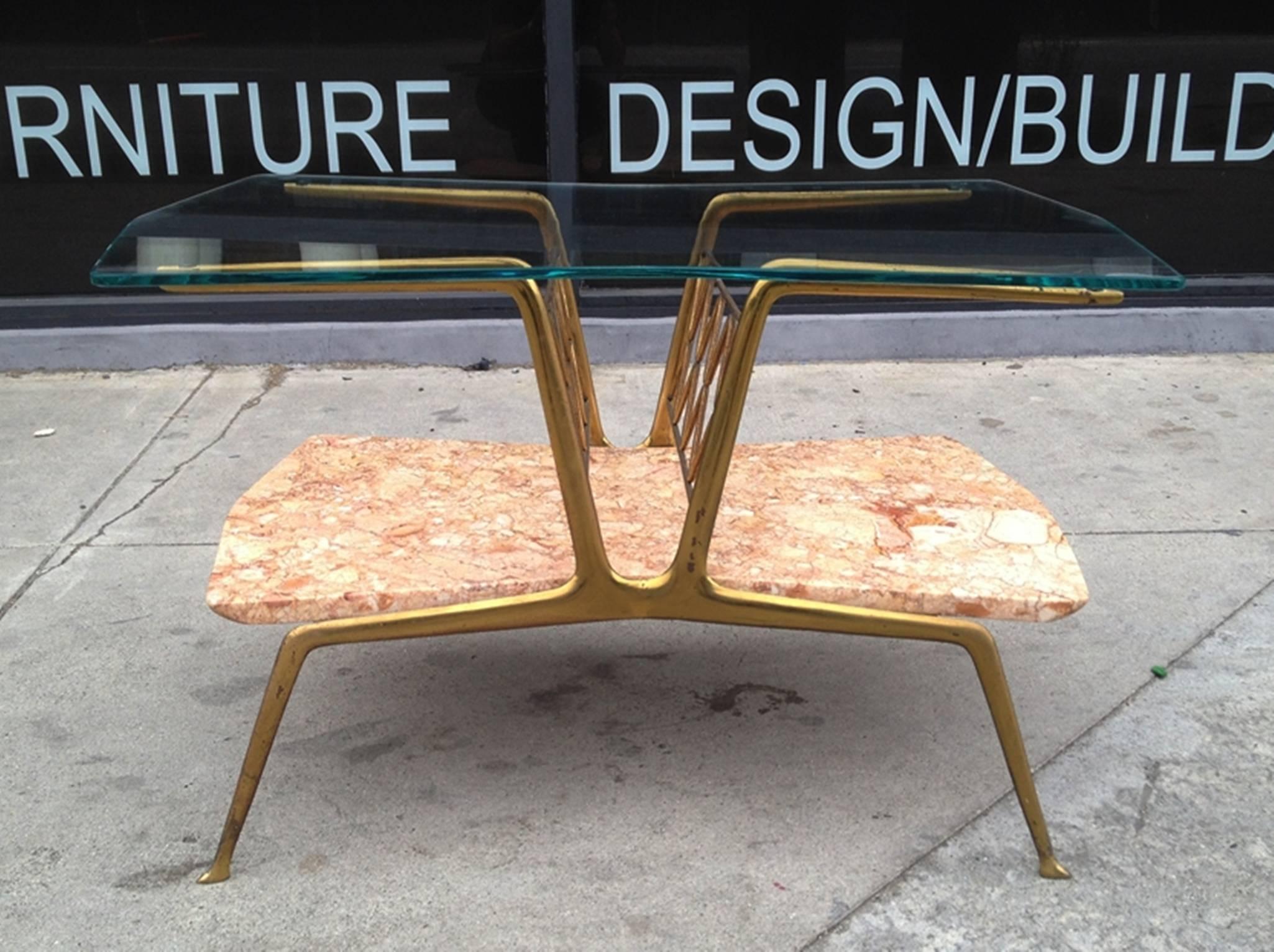 Beautiful Italian side table with a marble shelf and a glass top. 
The table is very much in the style of Gio Ponti but it is not marked, the brass has a beautiful aged patina and the marble and glass are all original.