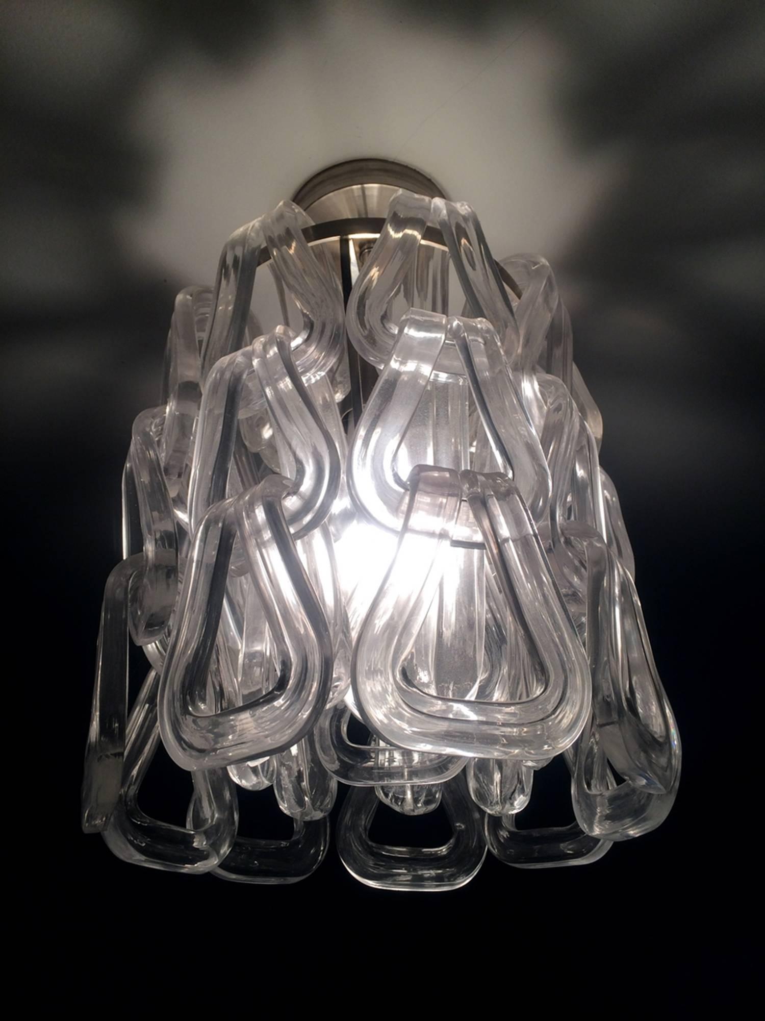Stunning Murano glass chandelier designed and manufactured by Mazzega. The chain like pendants drape over the chrome frame, the glass is heavy and thick but is very delicate to the eye.

These chandelier came out of a NY estate, they where