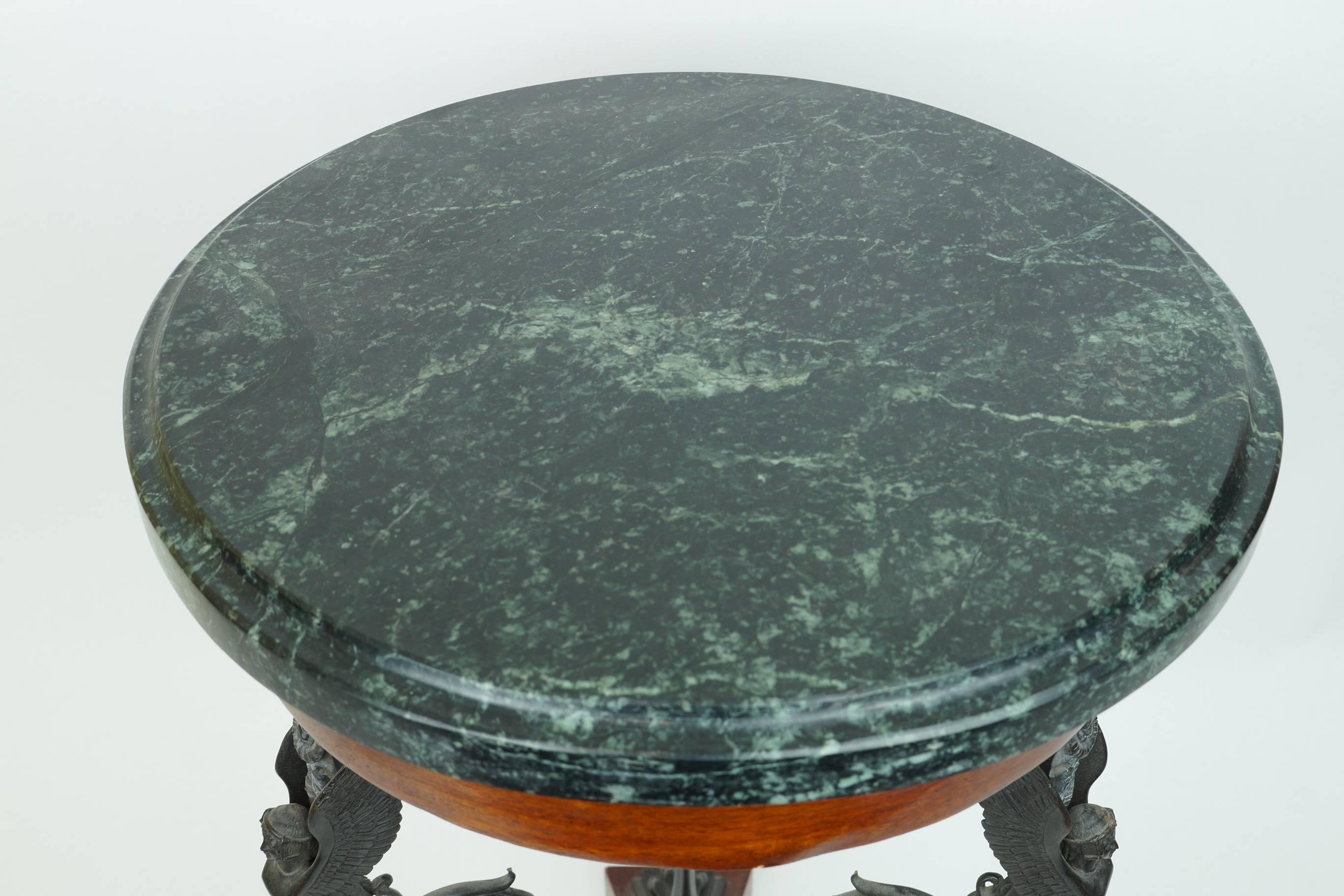 Neoclassical patinated bronze figural pedestal side table with winged figures and round marble top.
Stock Number: F61
