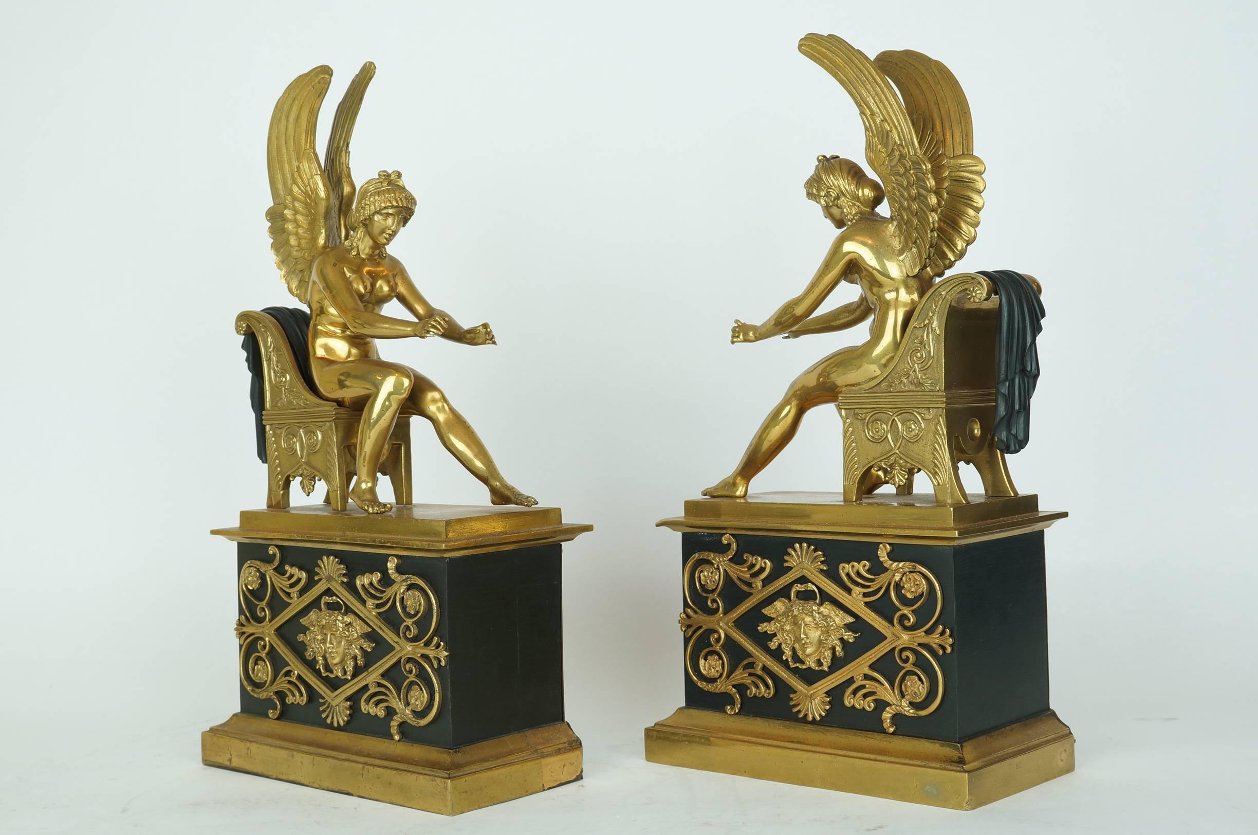 Neoclassical pair of French Empire style gilt bronze and patinated bronze fireplace chenets with seated winged figures on chairs.
Stock Number: MF18