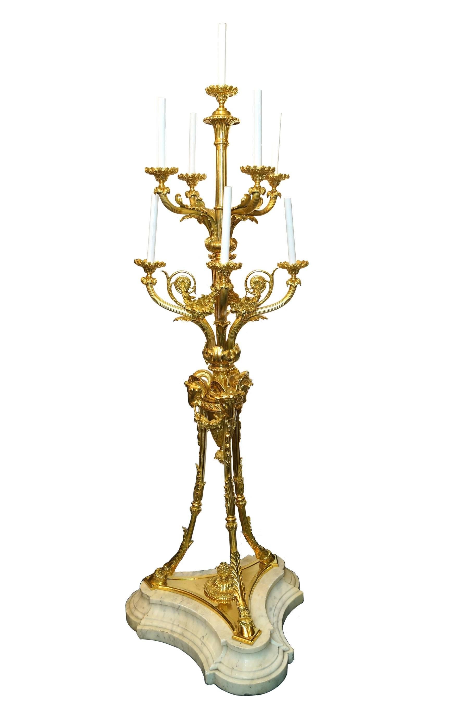 Pair of French Louis XVI style gilt bronze and marble nine-light torcher candelabra with Rams Head and Garlands.

Stock number: L404.