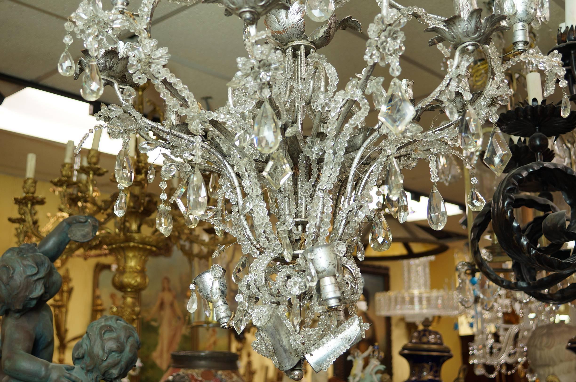 Important rock crystal and silvered metal beaded chandelier attributed to Baguès.