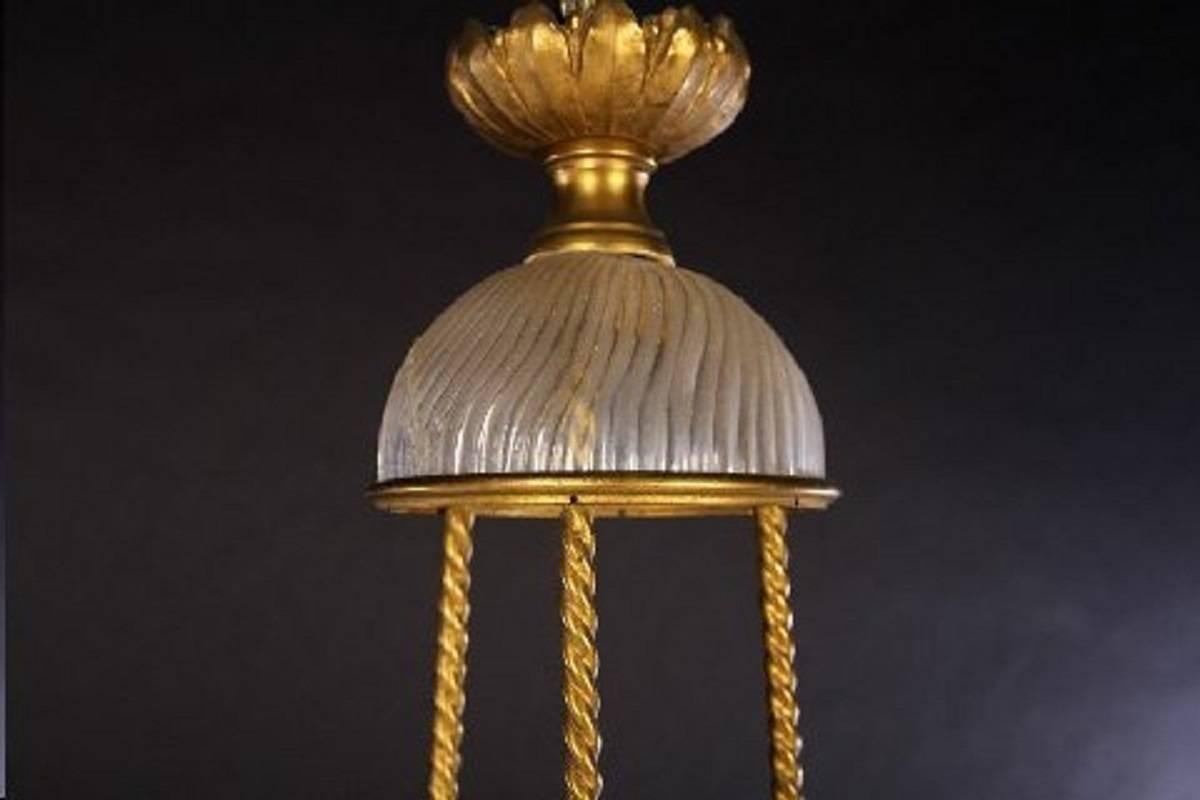 Louis XVI style three-arm bronze and twisted form glass chandelier attributed to Baccarat, having glass dome crown with rope twist bars supporting floral decorated pierced ring. Having half egg shaped glass shades, and three scrolling arms.