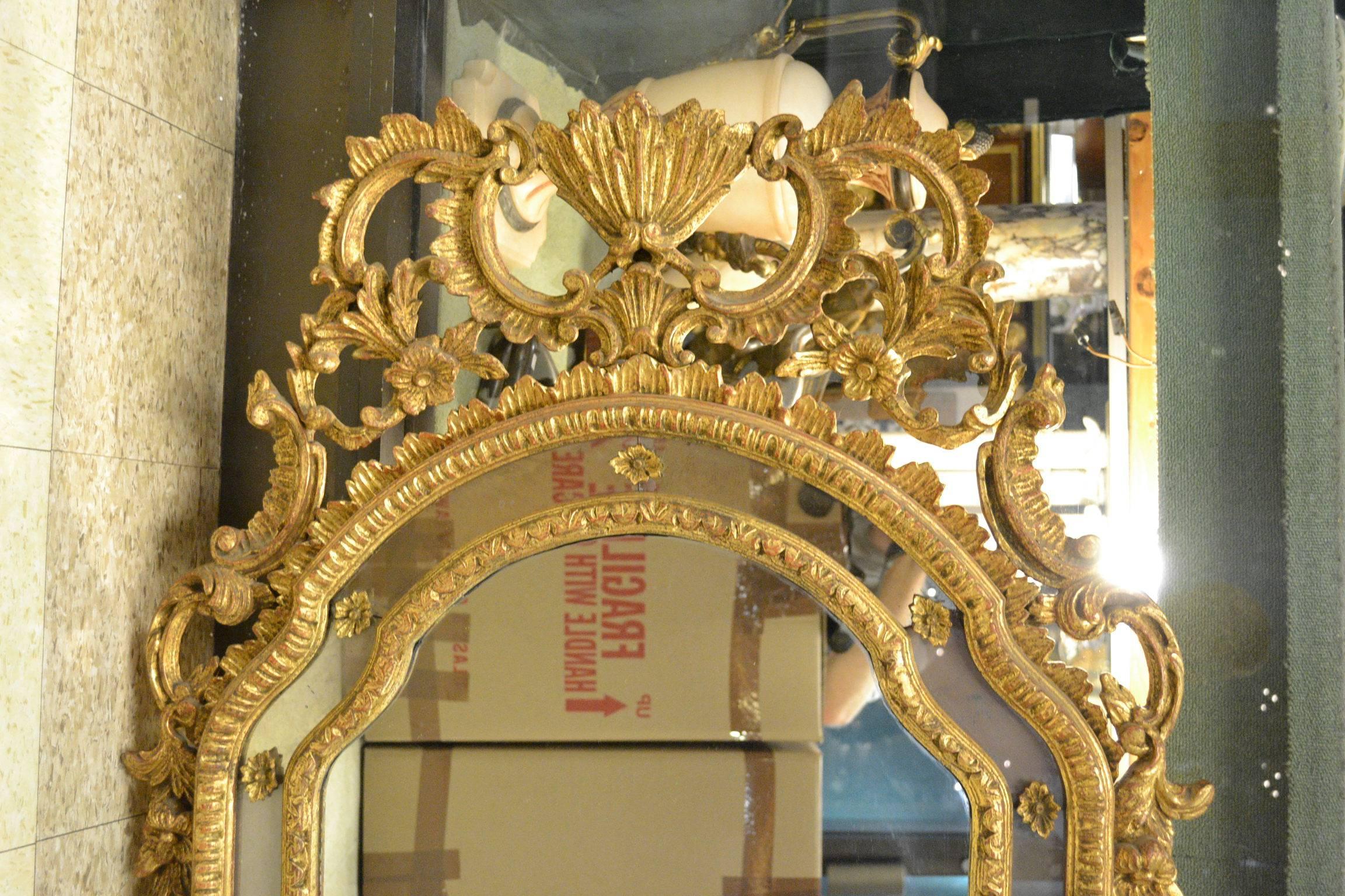 A very fine Rococo Venetian style giltwood and gesso mirror.