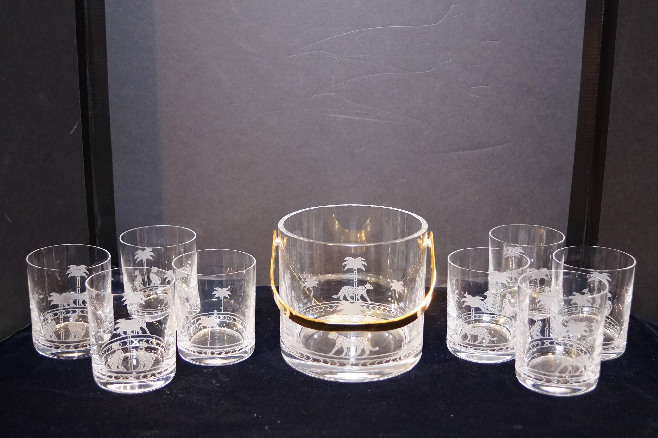 Christian Dior nine-piece ice bucket and glass set with etched panther pattern.
 